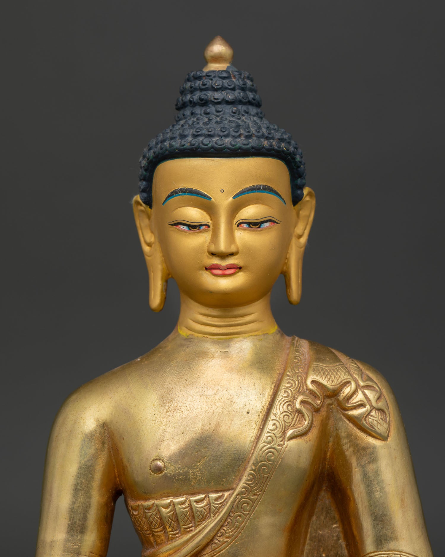 Amitabha Buddha Statue Close Up Gold Painted Face and Hand Carved Monk Robe.