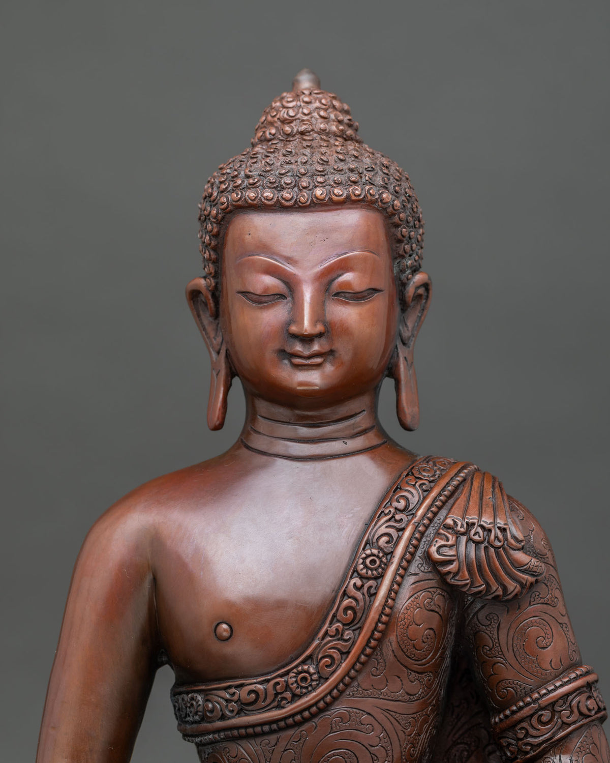 Amitabha buddha statue close up serene face and oxidized copper finish