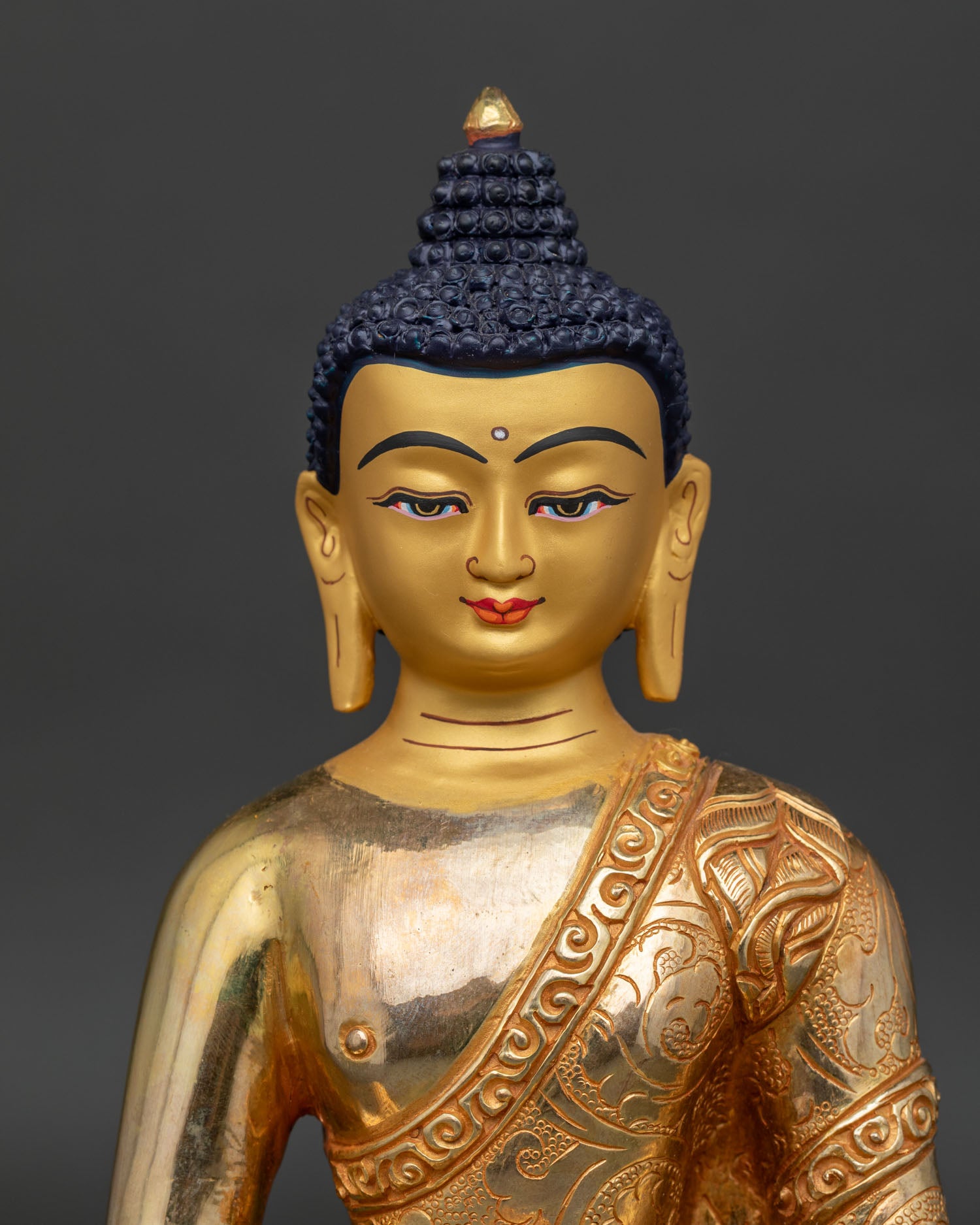 Amitabha Buddha Statue close up view showing gold-painted face and intricate floral robe carvings