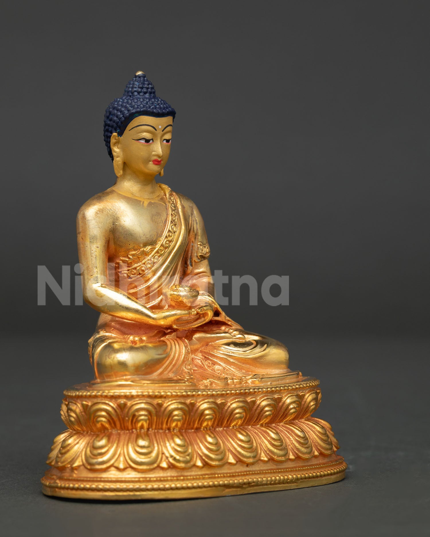 Amitabha Buddha statue detailed robe close up with hand carved floral motifs and alms bowl.