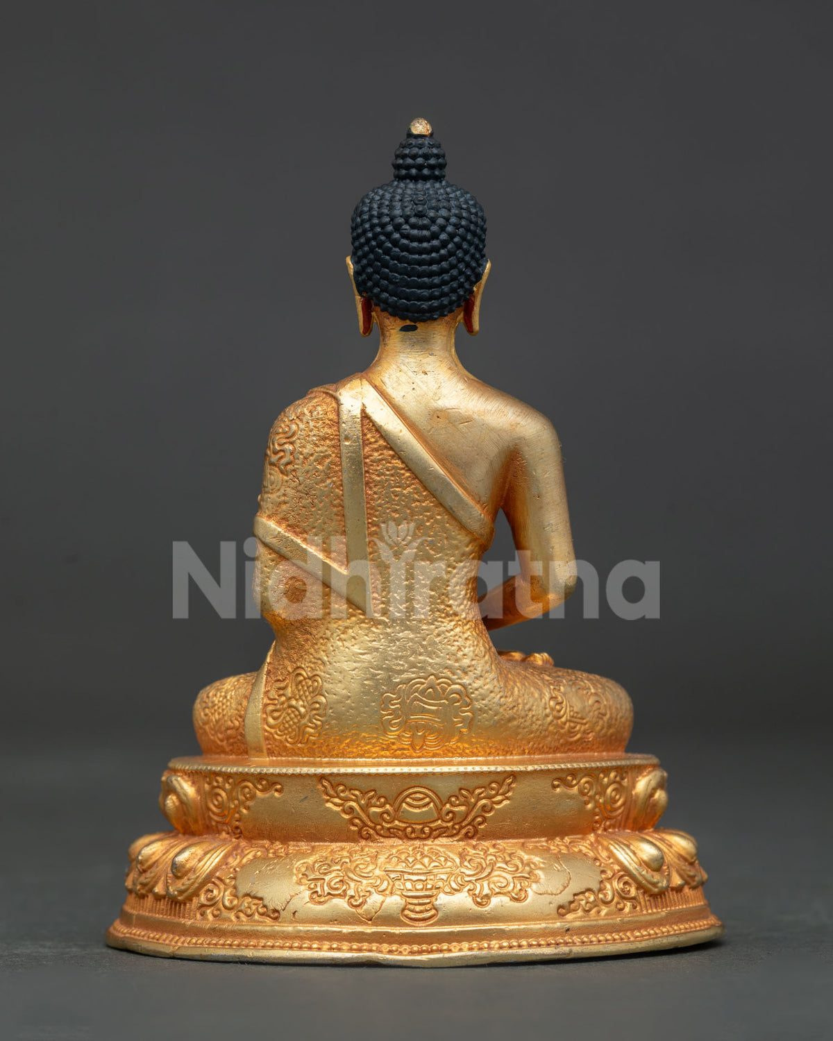 Amitabha Buddha statue in dhyana mudra holding traditional alms bowl with ornate robe.
