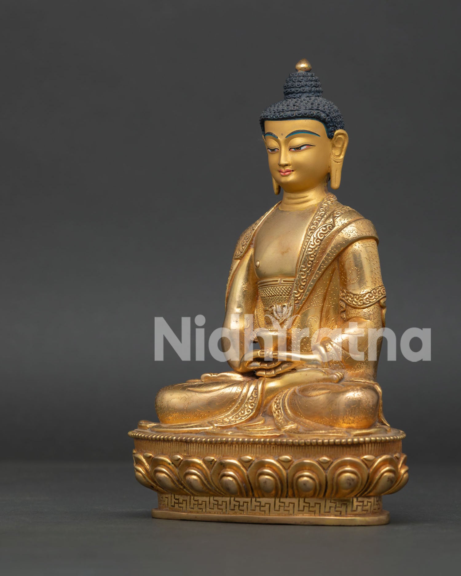 Amitabha Buddha statue showing Dhyana Mudra Patra and floral robe carving.