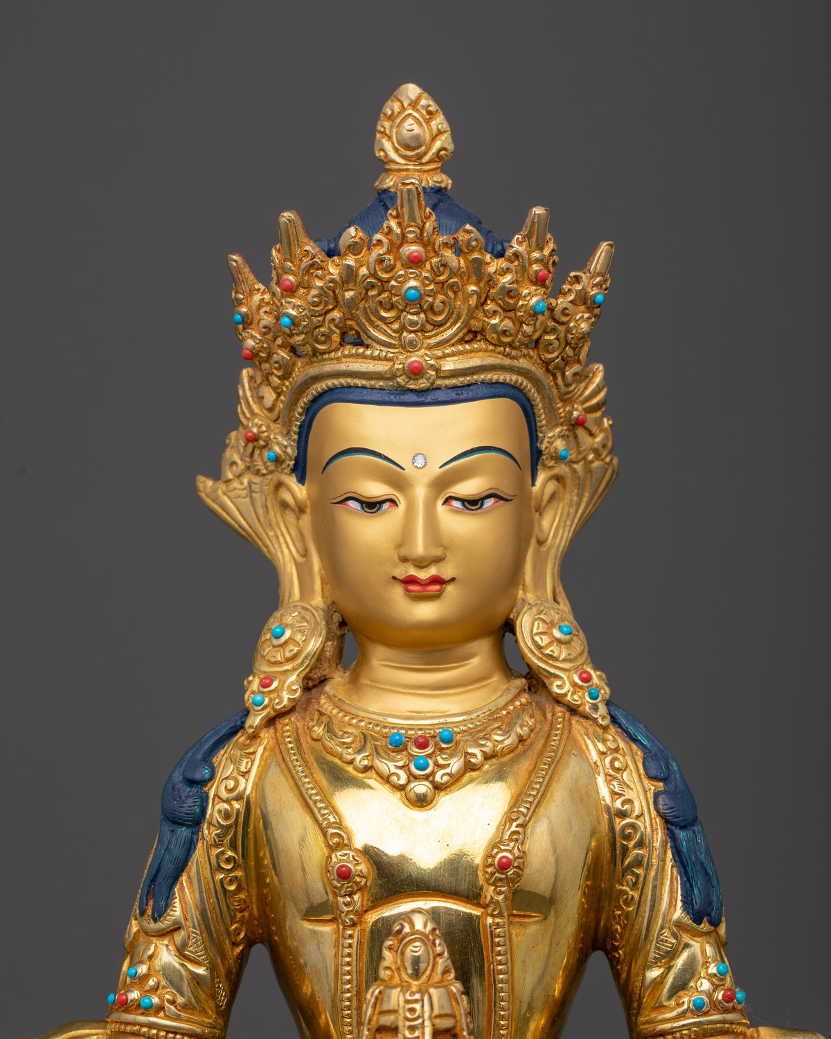 Amitayus Buddha face with detailed gold-painted features and intricate traditional Nepalese metalwork