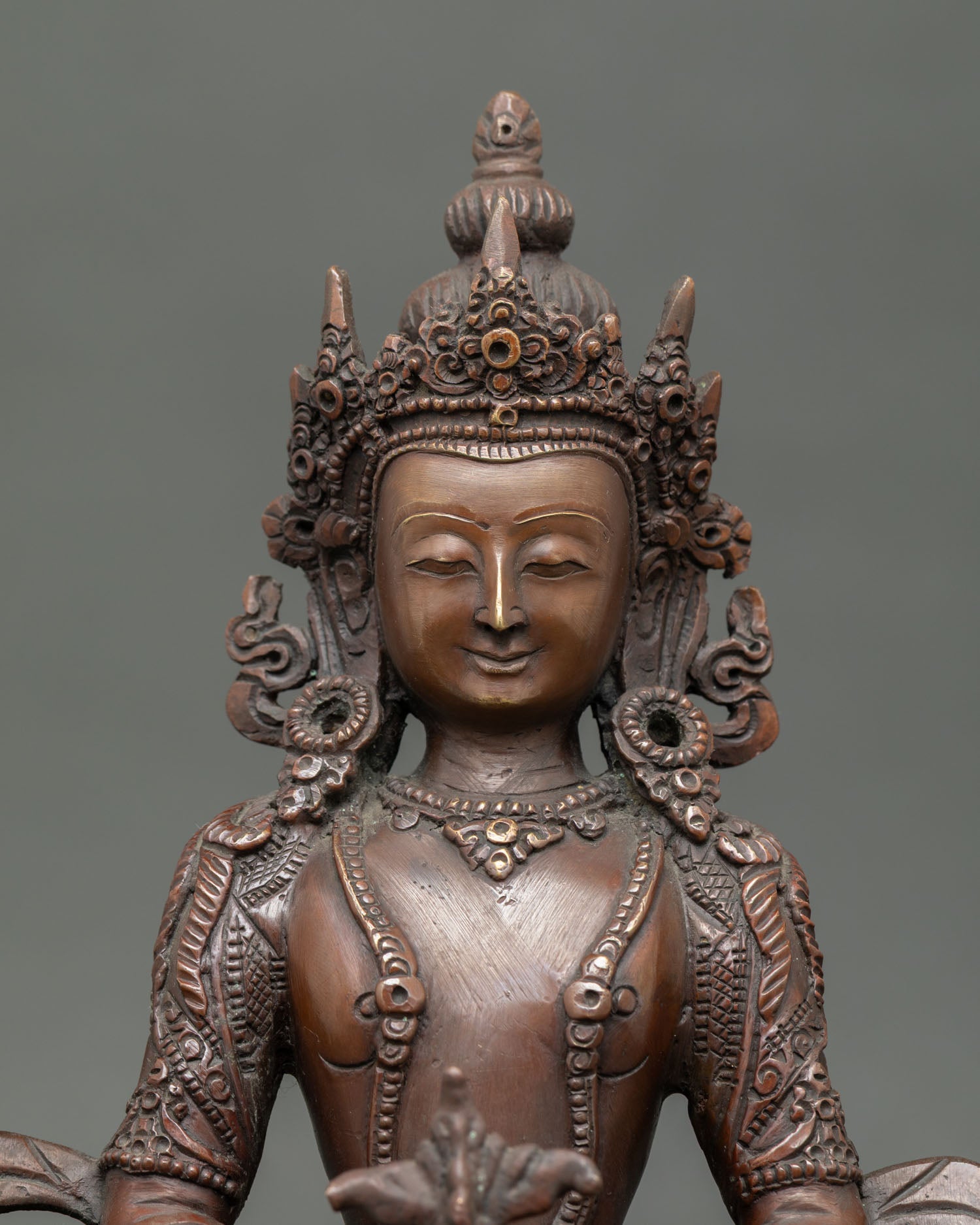 Amitayus Buddha face with an oxidized finish, Nepalese Buddhist art.