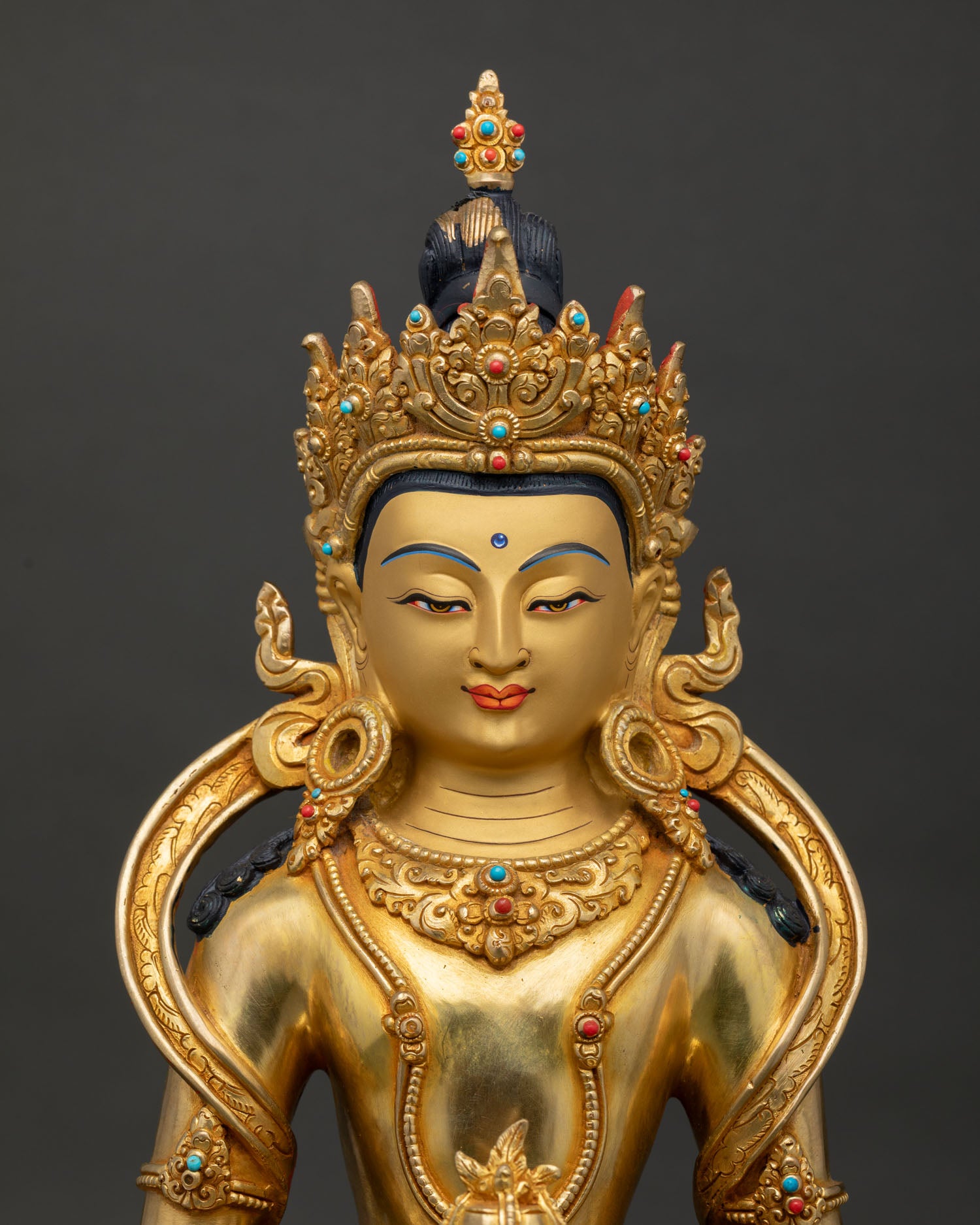Amitayus Buddha sculpture close-up showing intricate copper details and sacred Buddhist artistry