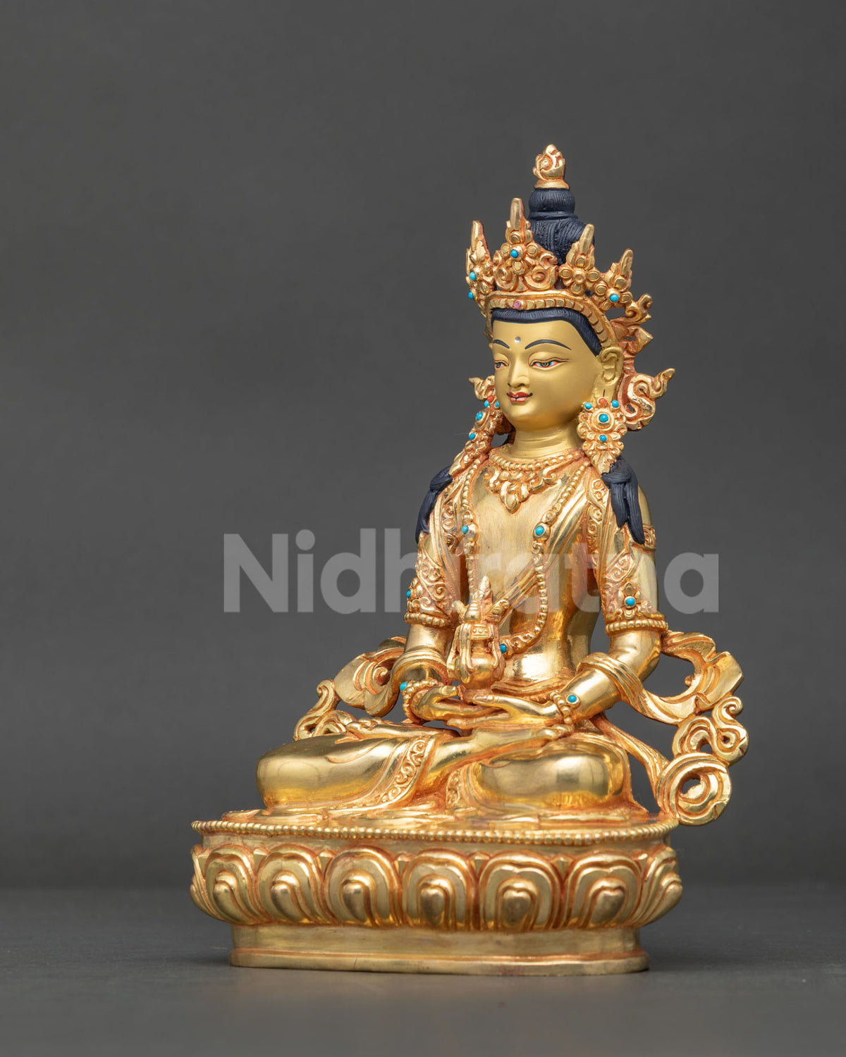Amitayus buddha seated on lotus pedestal with hand carved silk garment and jewel crown.