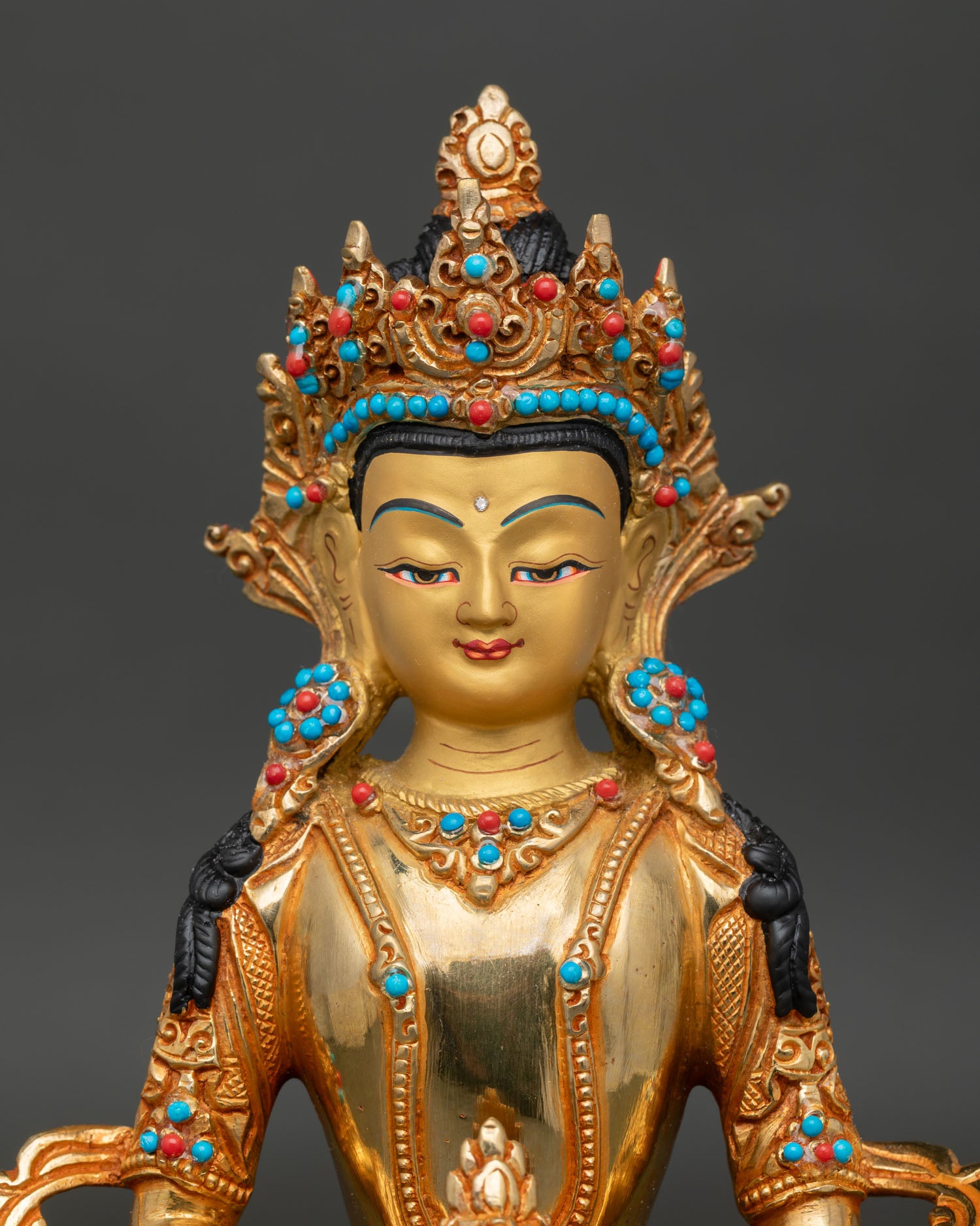 Amitayus Buddha statue close up showing gold gilded details and sacred ornaments