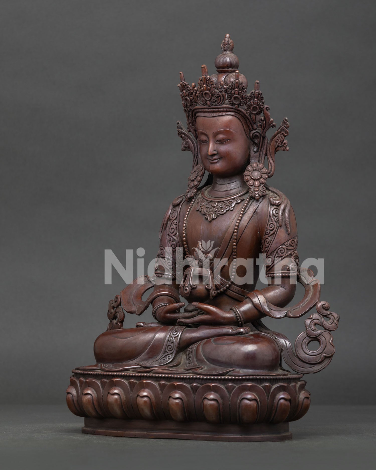 Amitayus Buddha statue side view showing lotus pedestal and antique oxidized copper finish.