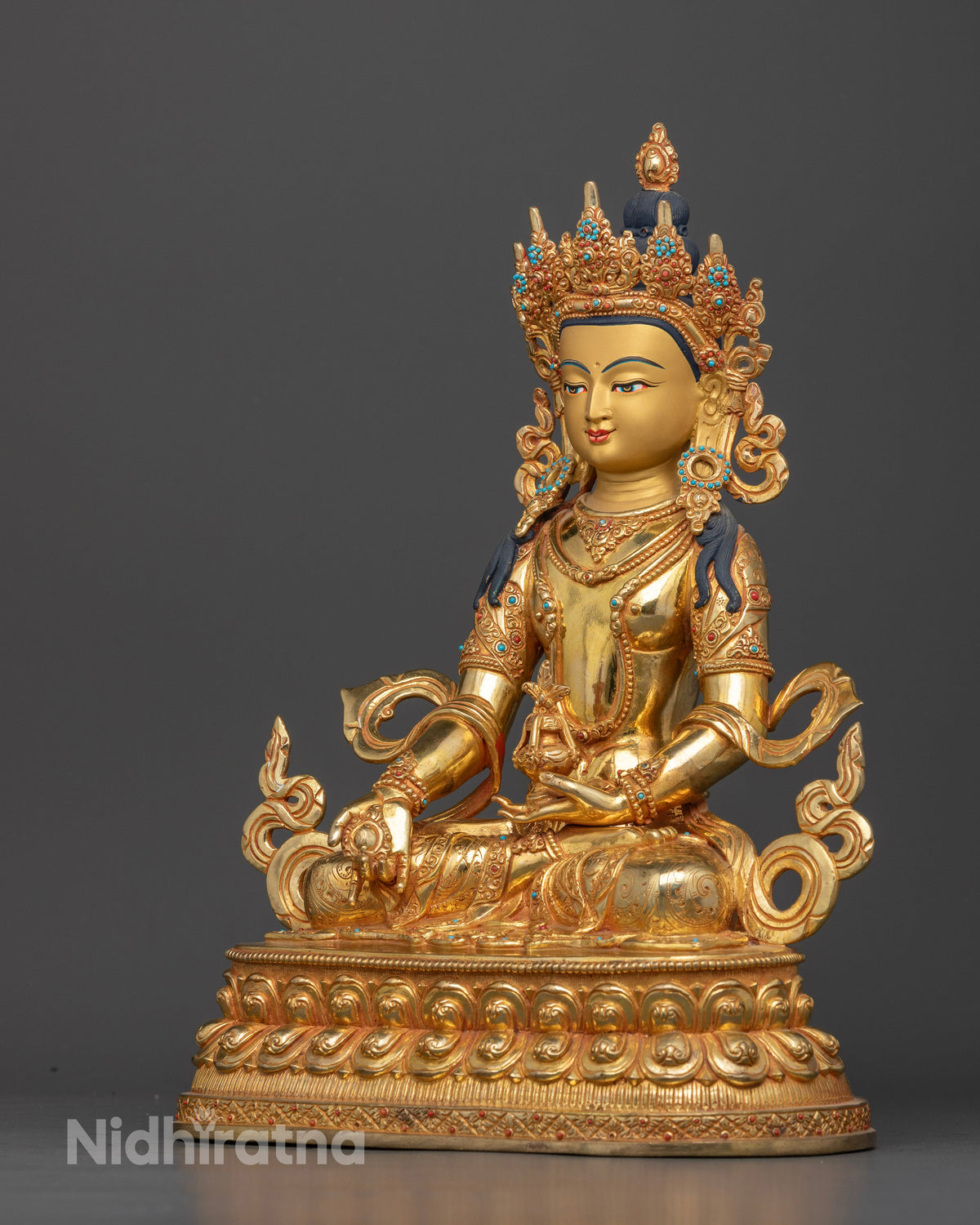 Amitayus Buddha statue with five jewel crown and celestial jewelry.