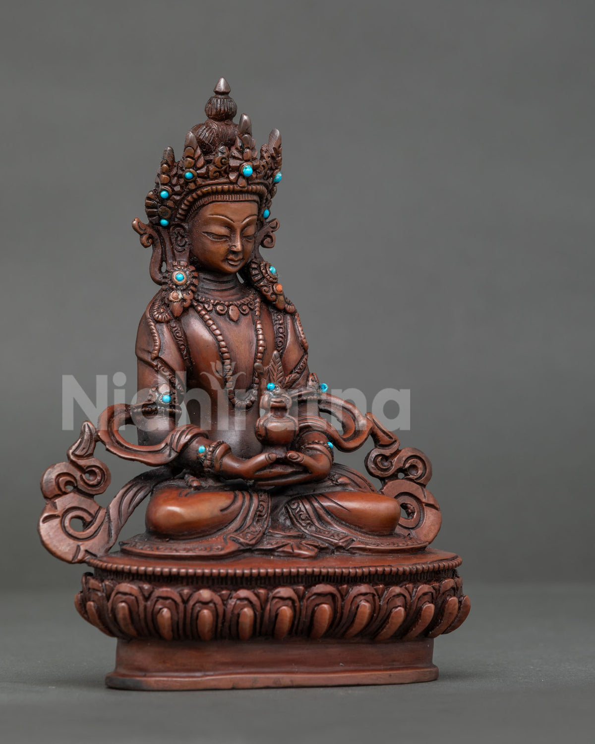 Amitayus seated on handcarved lotus pedestal holding kalasha with both hands.