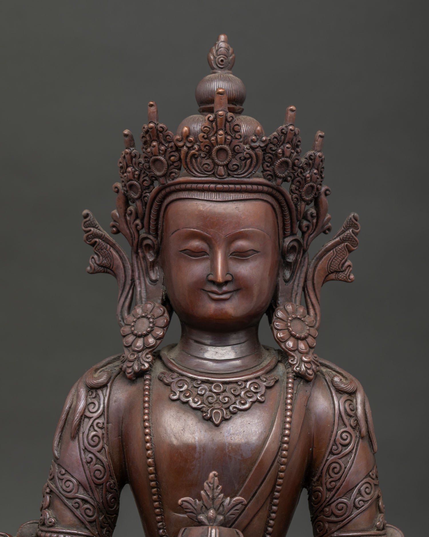 Amitayus statue face close up highlighting serene expression and detailed Nepalese craftsmanship.