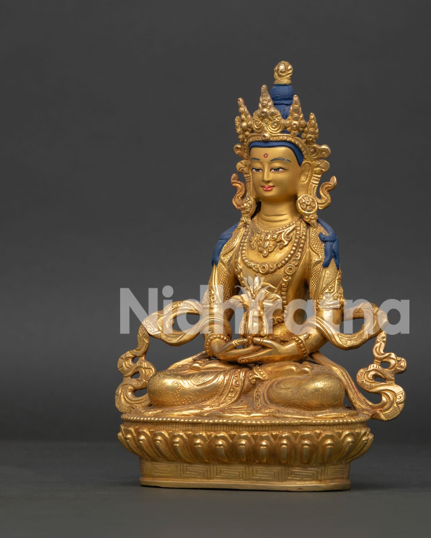 Amitayus statue side view with lotus throne and floral silk garment.