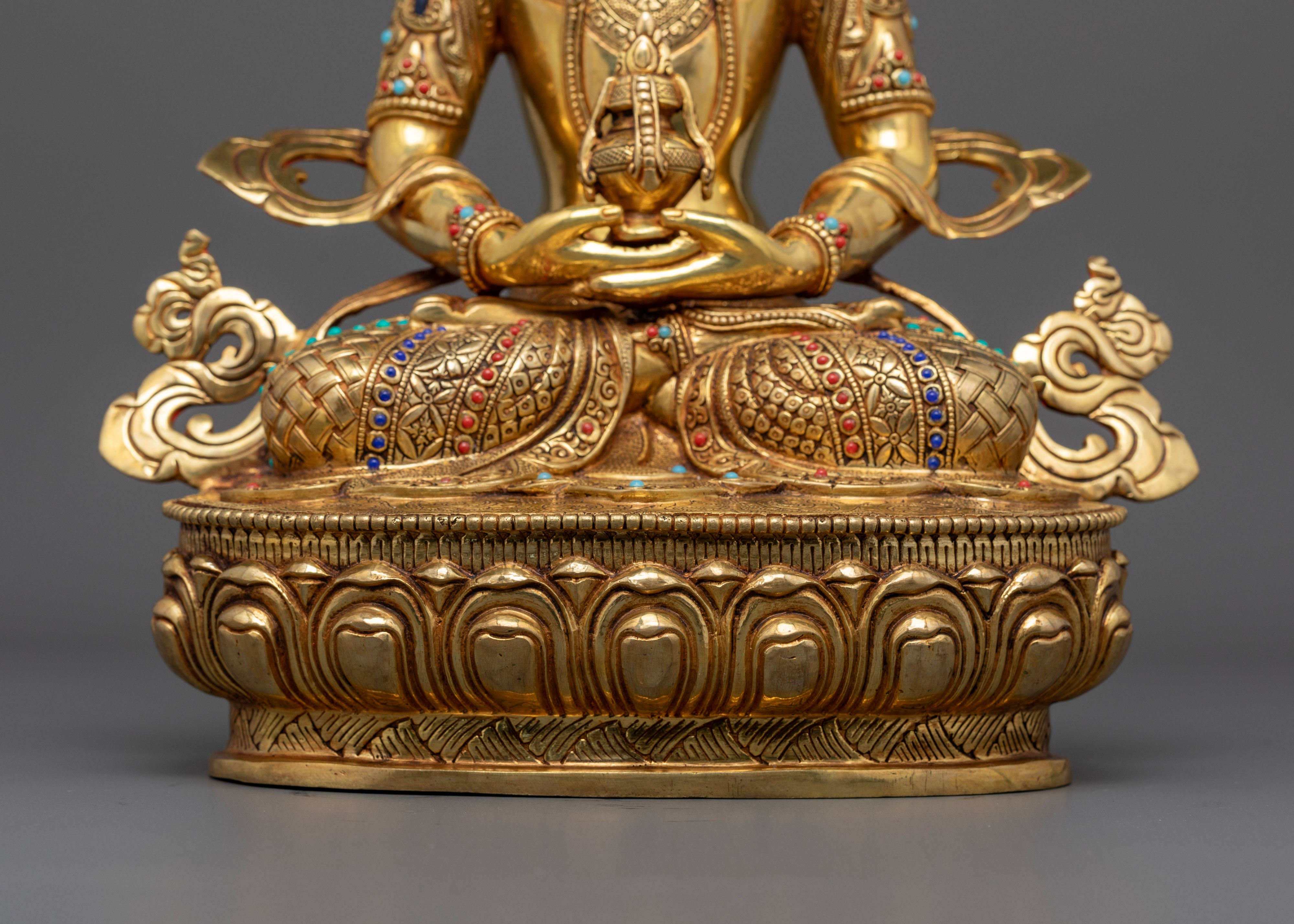 amitayus buddha statue sitting on top of moon disc on a lotus seat