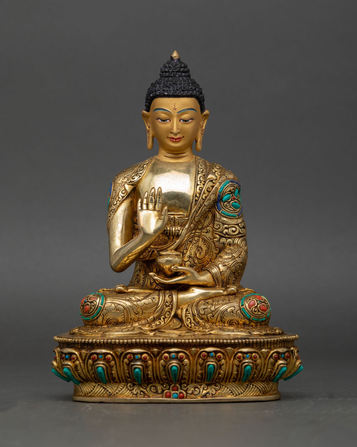 Amoghasiddhi Buddha raised right hand abhaya mudra fearlessness protection symbol copper gold painted face lotus throne nepal