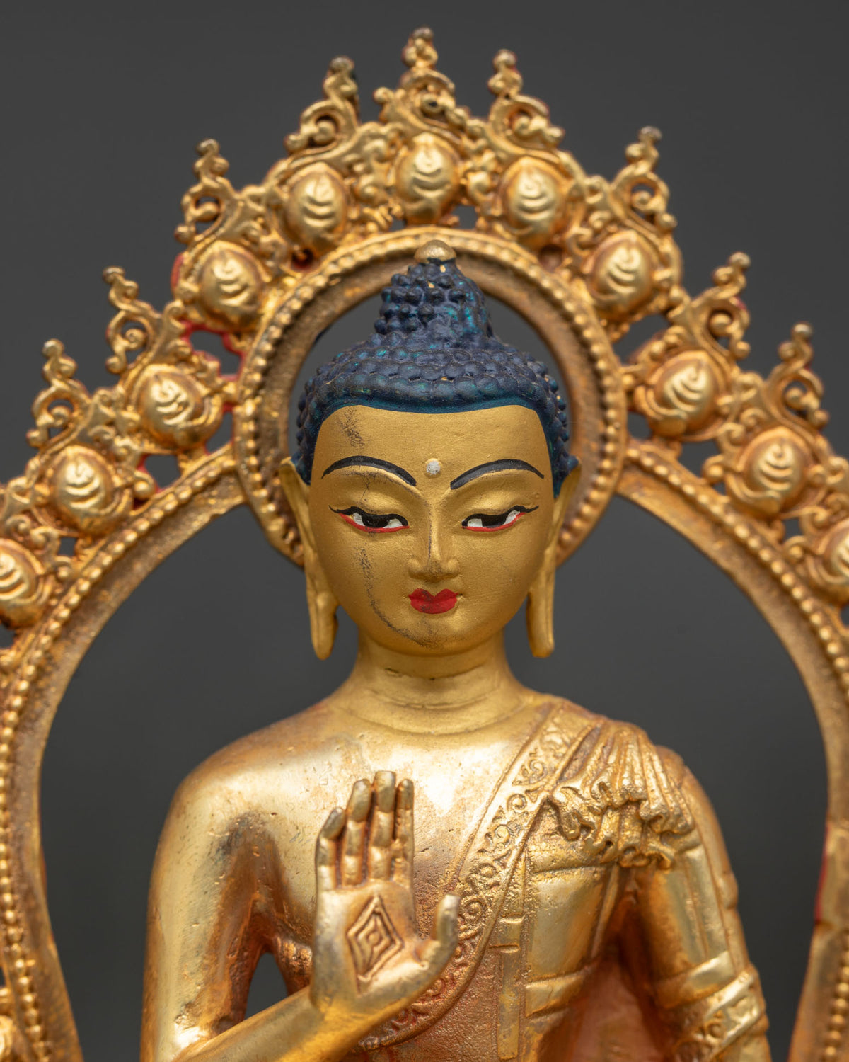 Amoghasiddhi Buddha statue detailed face and hand carved patterned monk robe.