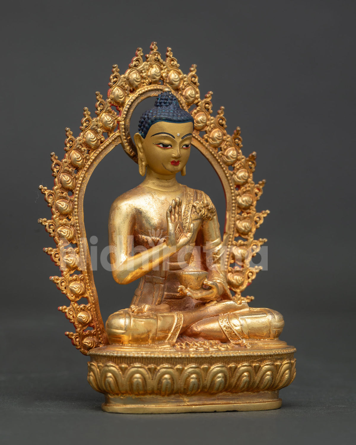 Amoghasiddhi Buddha statue gold painted face hand carved lotus pedestal and halo.