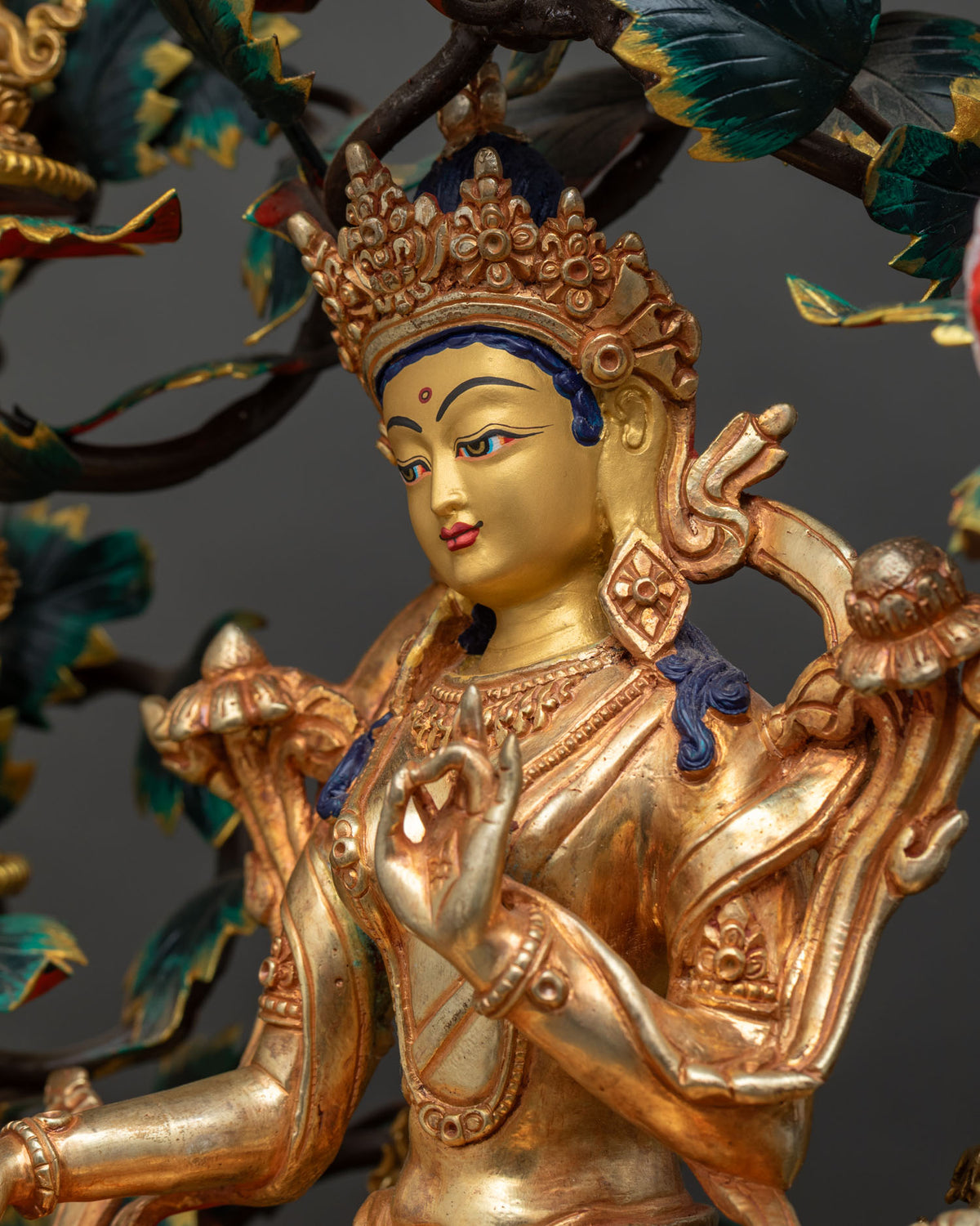 Angled close-up of Green Tara in 24K gold fire-gilding with blue hair, 21 Tara Statue Set