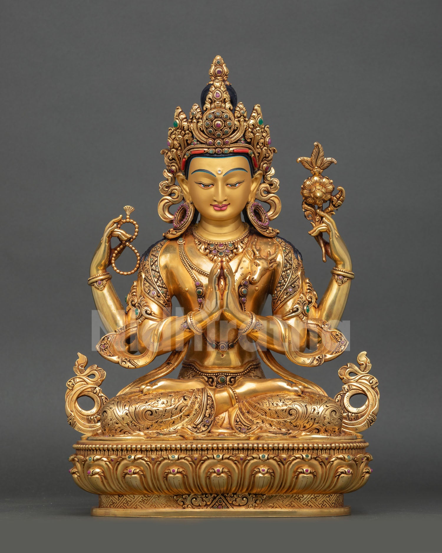 Avalokiteshvara Chenrezig statue with four arms and lotus detail in Tibetan Buddhist art