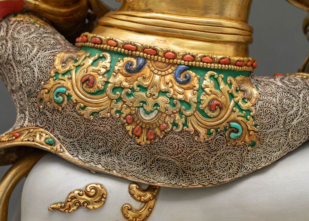 Back close-up of Namtoshe statue showing gold-gilded torso and filigree lower garment with stone inlay