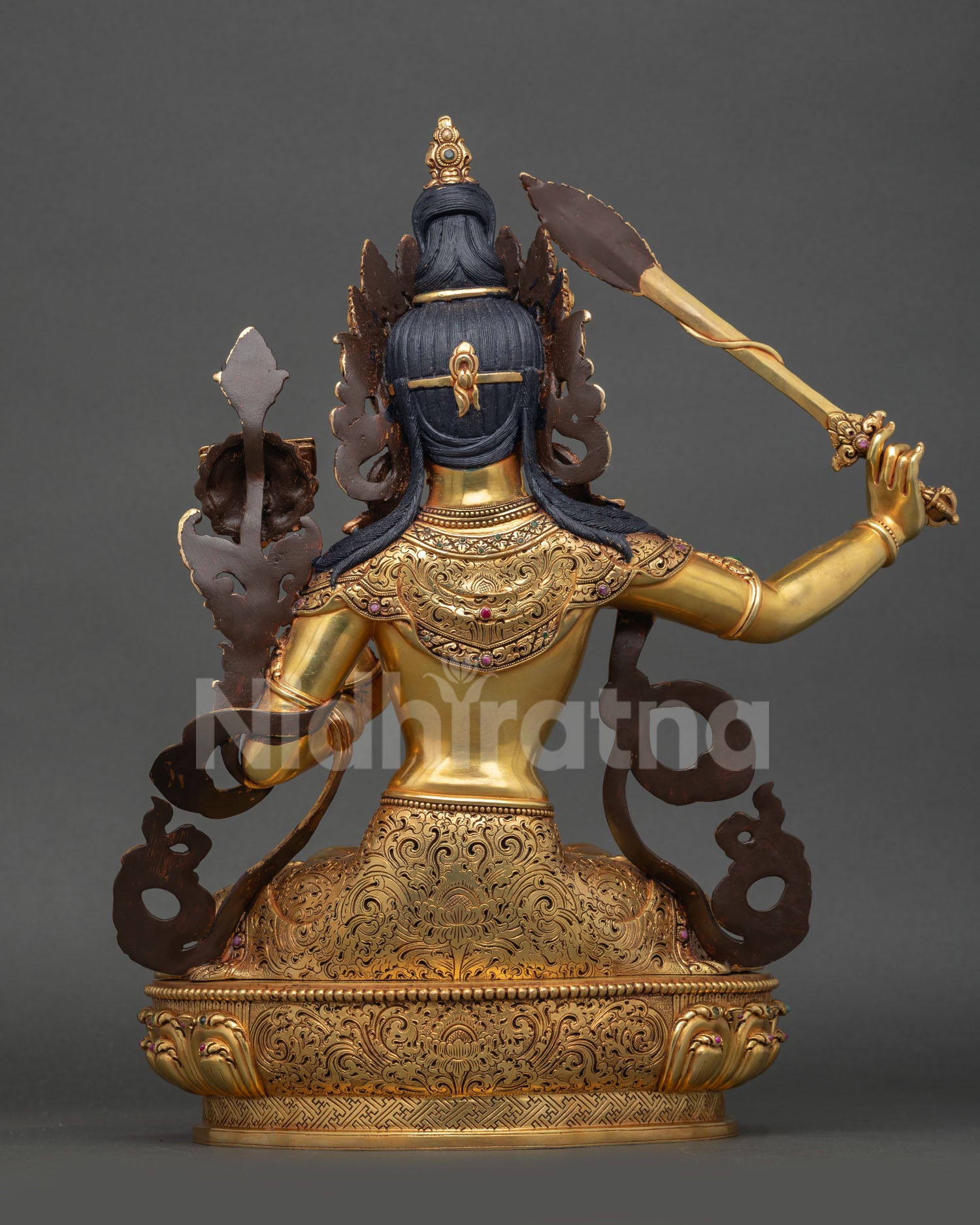 Back view: back detail Manjushri statue Nepalese craftsmanship copper body engraved robes lotus pedestal design