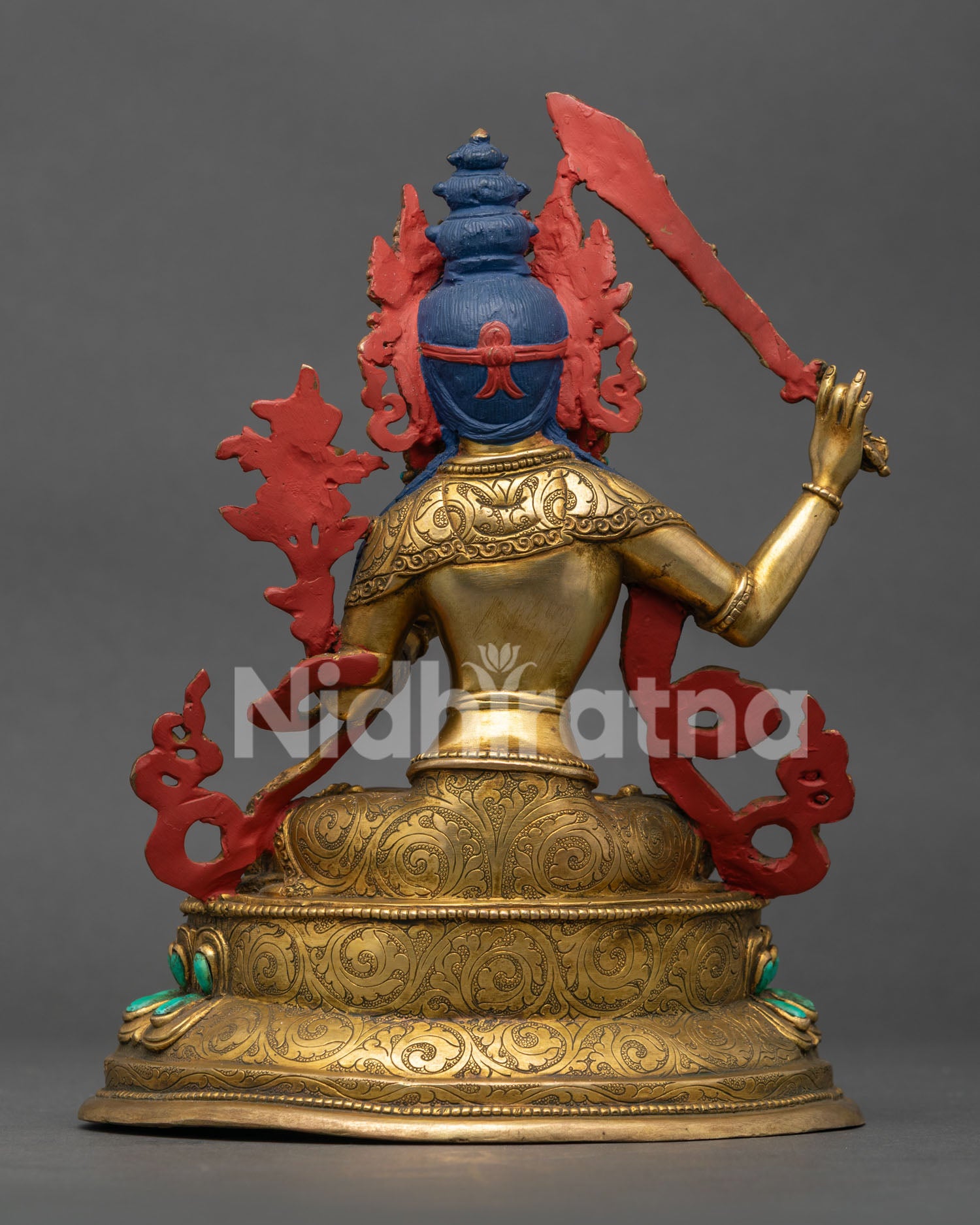 back of manjushri statue with detailed robe engravings and traditional nepalese craftsmanship