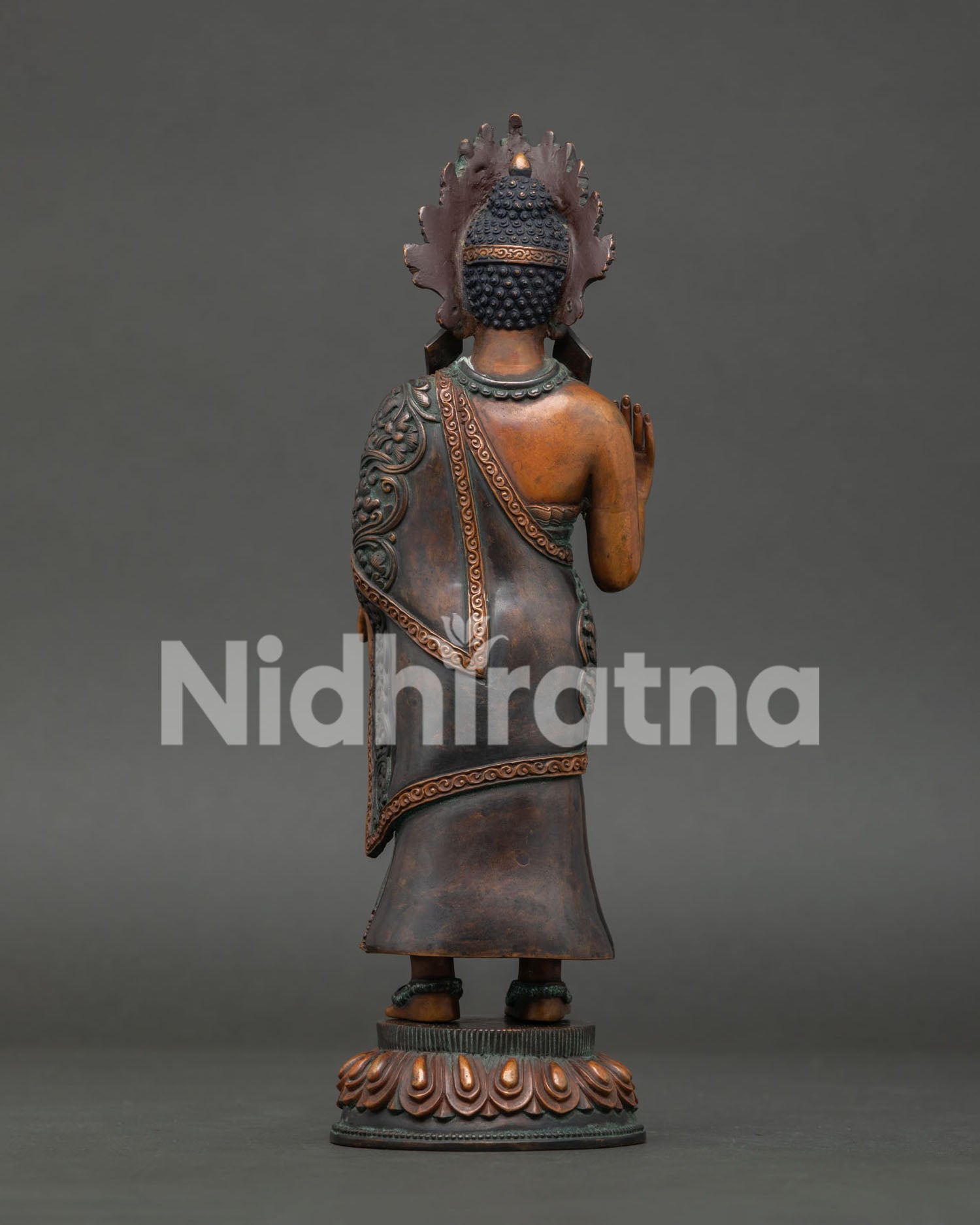 back of standing dipankara buddha statue showing detailed robes and artisan craftsmanship