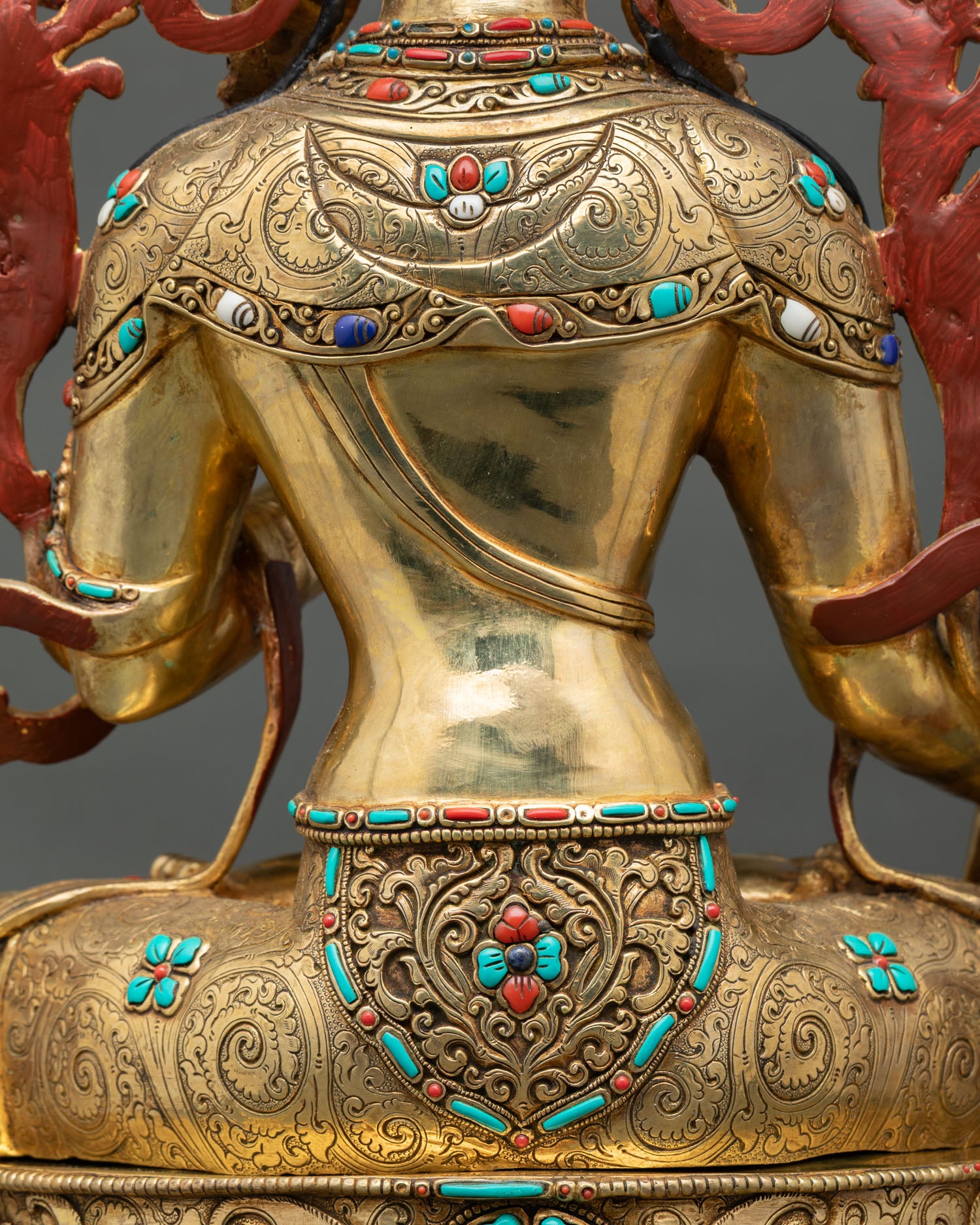 Back torso detail of White Tara statue with repoussé carvings and gemstone embellishments