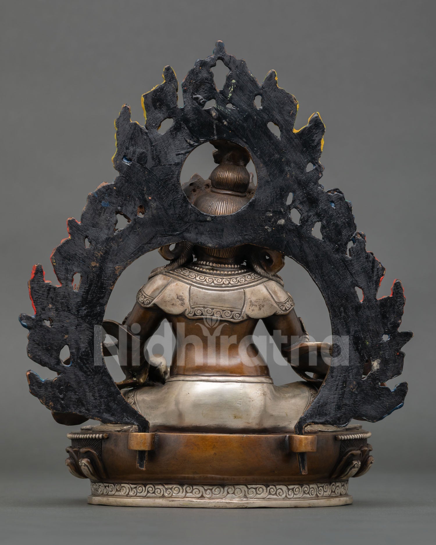 back view Dzambhala statue, detailed halo design and engraved sacred patterns