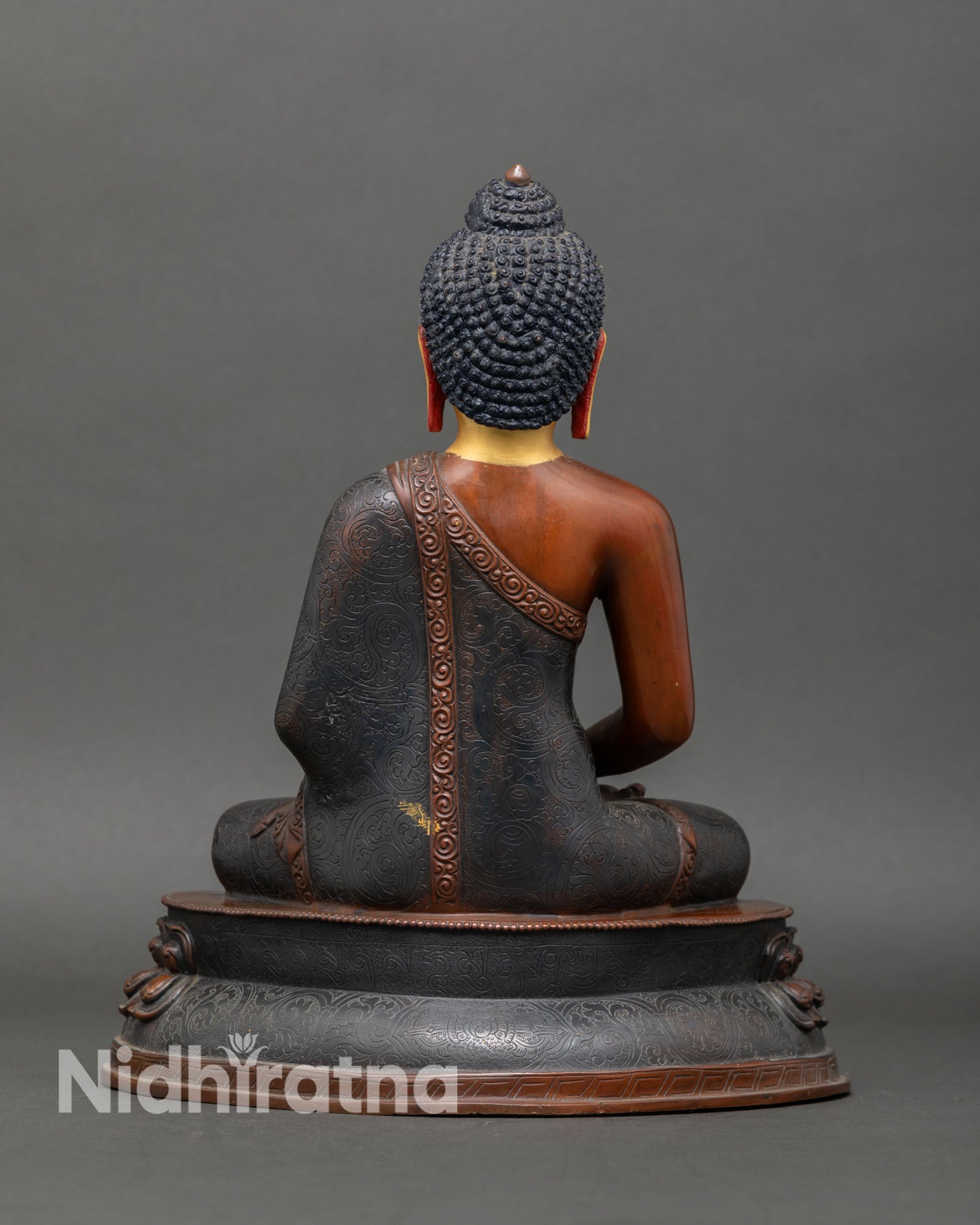 Back view of Amitabha Buddha statue flowing robes detailed carving oxidized copper handmade Nepal Buddhist sacred art