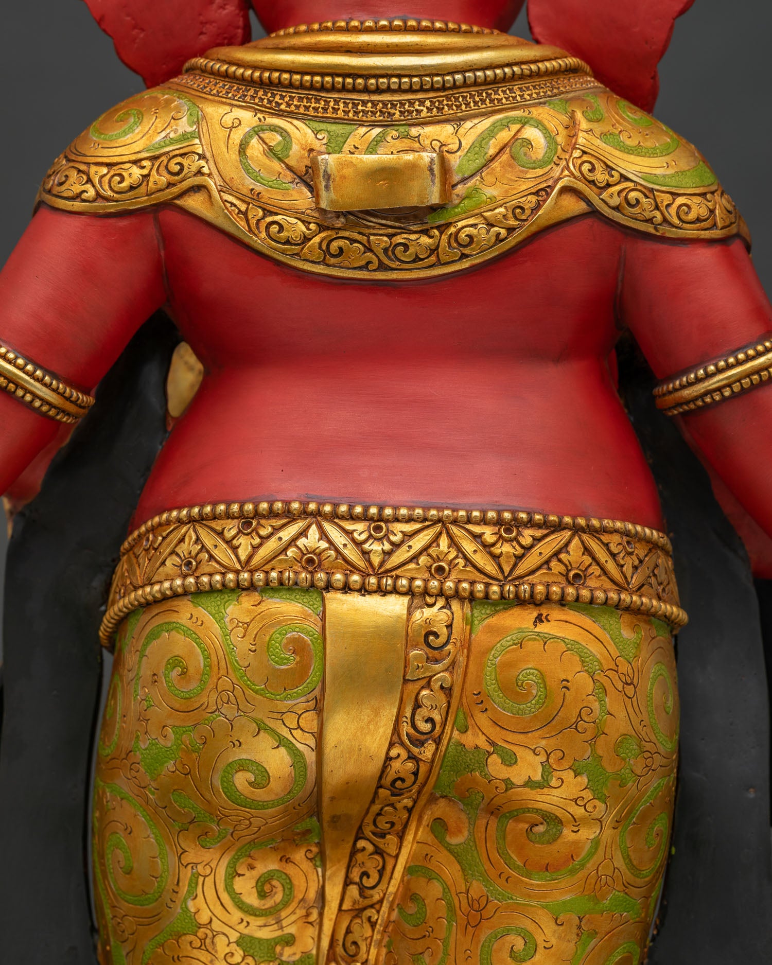 Back view close-up of Ganesha statue shoulder and gold ornament detailing