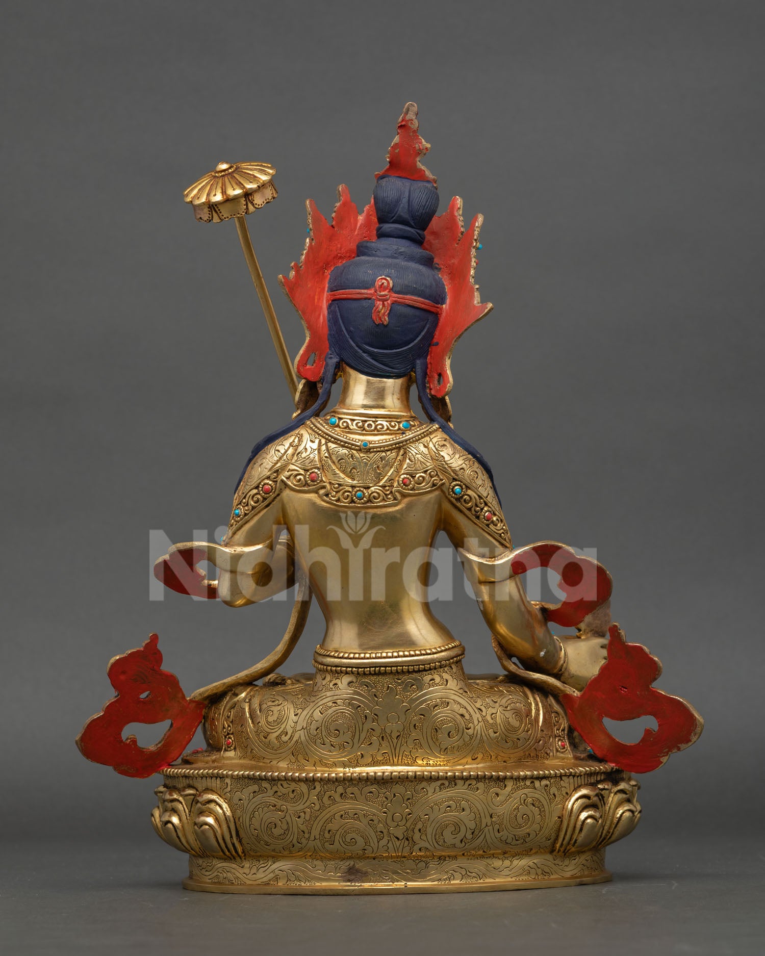Back view of Dukar Buddhist statue with finely carved lotus base, Himalayan metal craftsmanship reflecting sacred protective energy and serene presence.