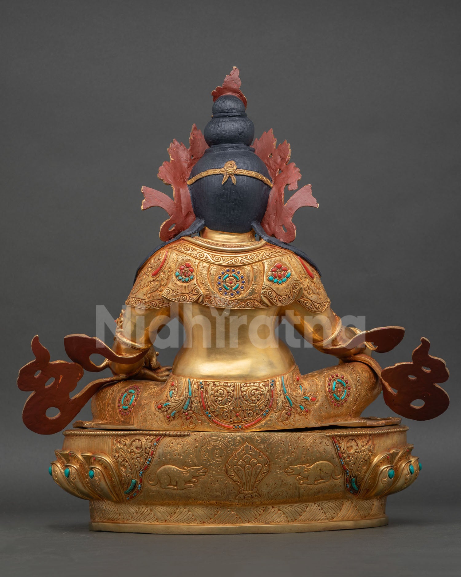 Back view of Dzambhala statue, detailed copper finish, traditional Himalayan Buddhist sculpture, gold gilding artisan craft from Patan, Nepal