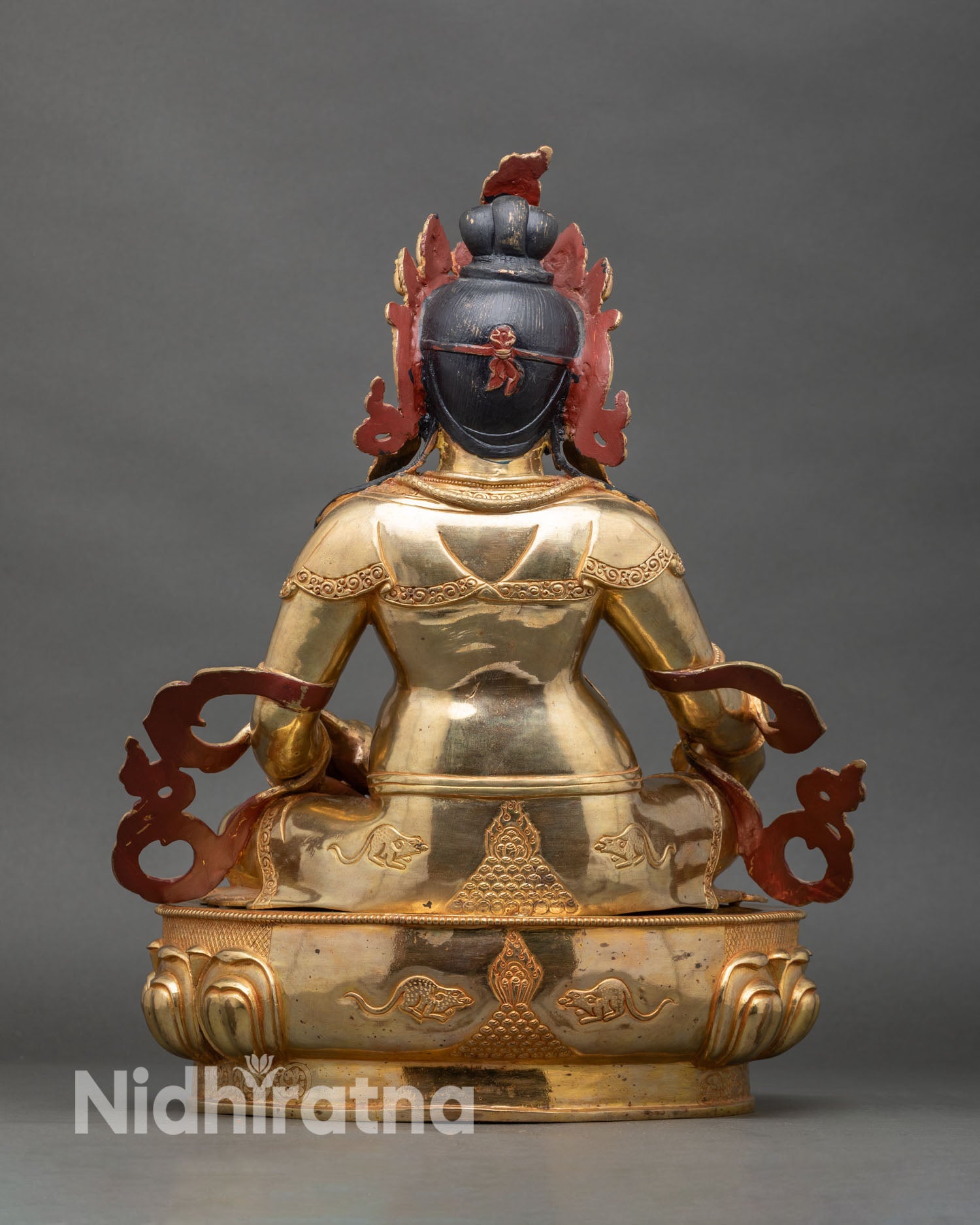 Back view of Dzambhala Statue, detailed lotus throne and decorative garments, Nepalese art