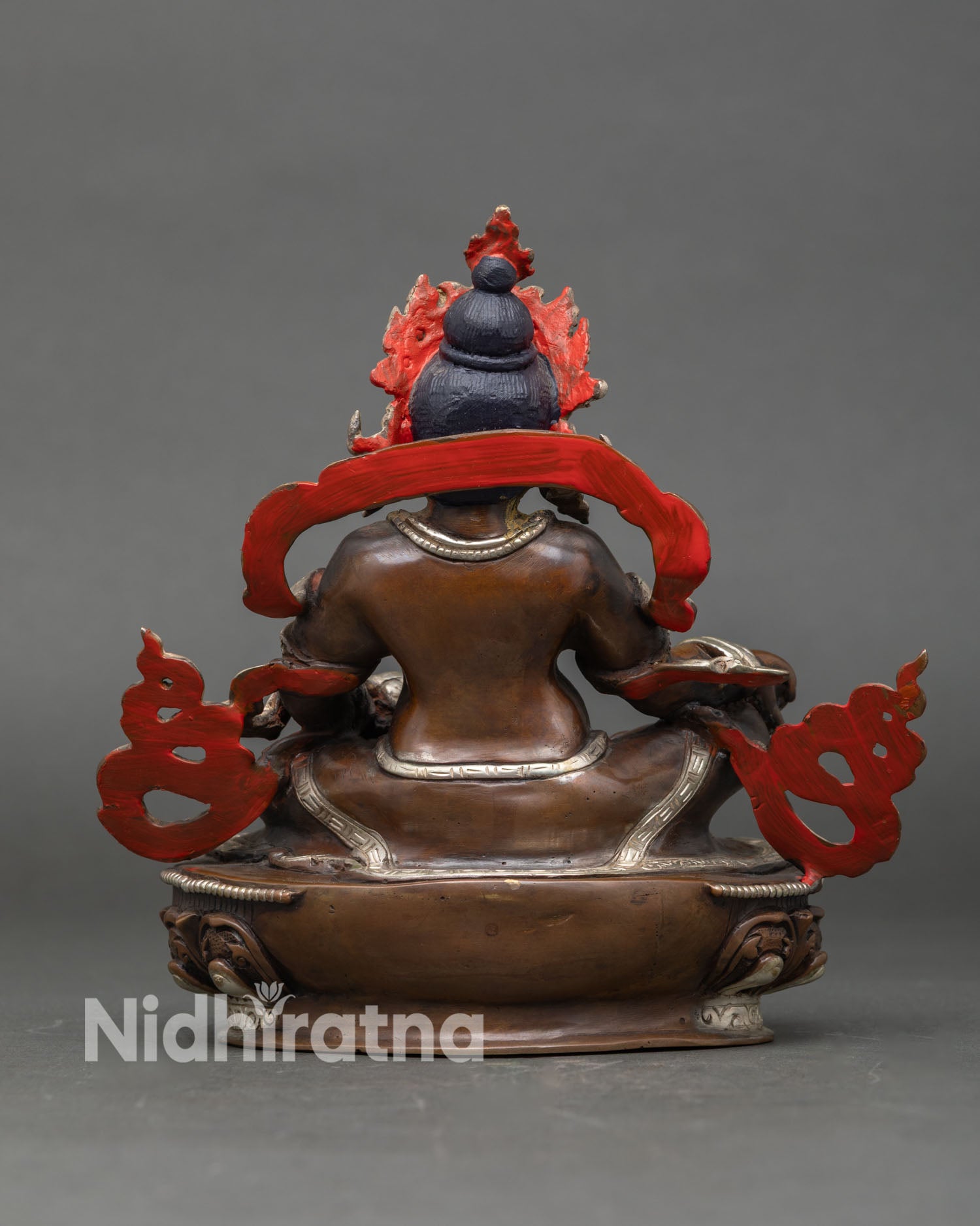 Back view of the handcrafted Dzambhala statue, a Tibetan Buddhist deity from Nepal.