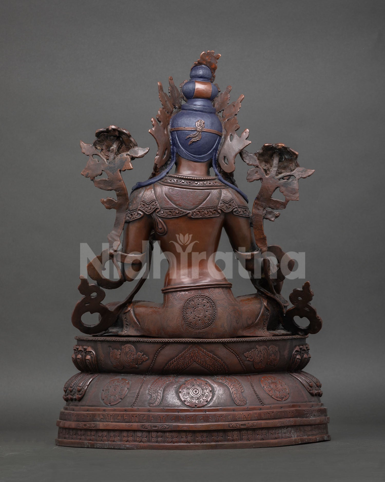 Back view of Green Tara statue, oxidized copper, detailed robe patterns, traditional Himalayan Buddhist sculpture