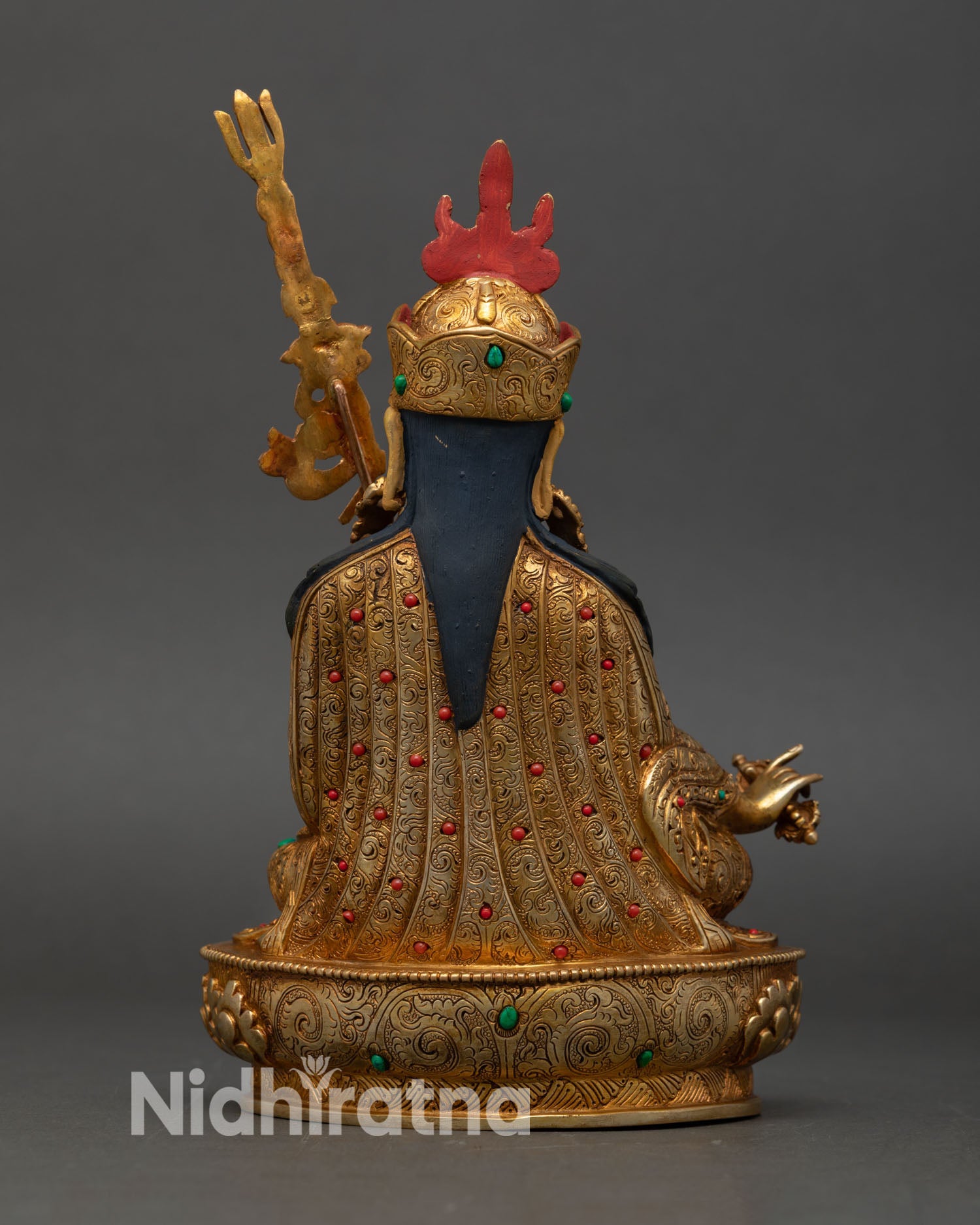 Back view of Guru Rinpoche statue handcrafted Nepal, intricate carving layered robes lotus pedestal, sacred Vajrayana Buddhist deity art