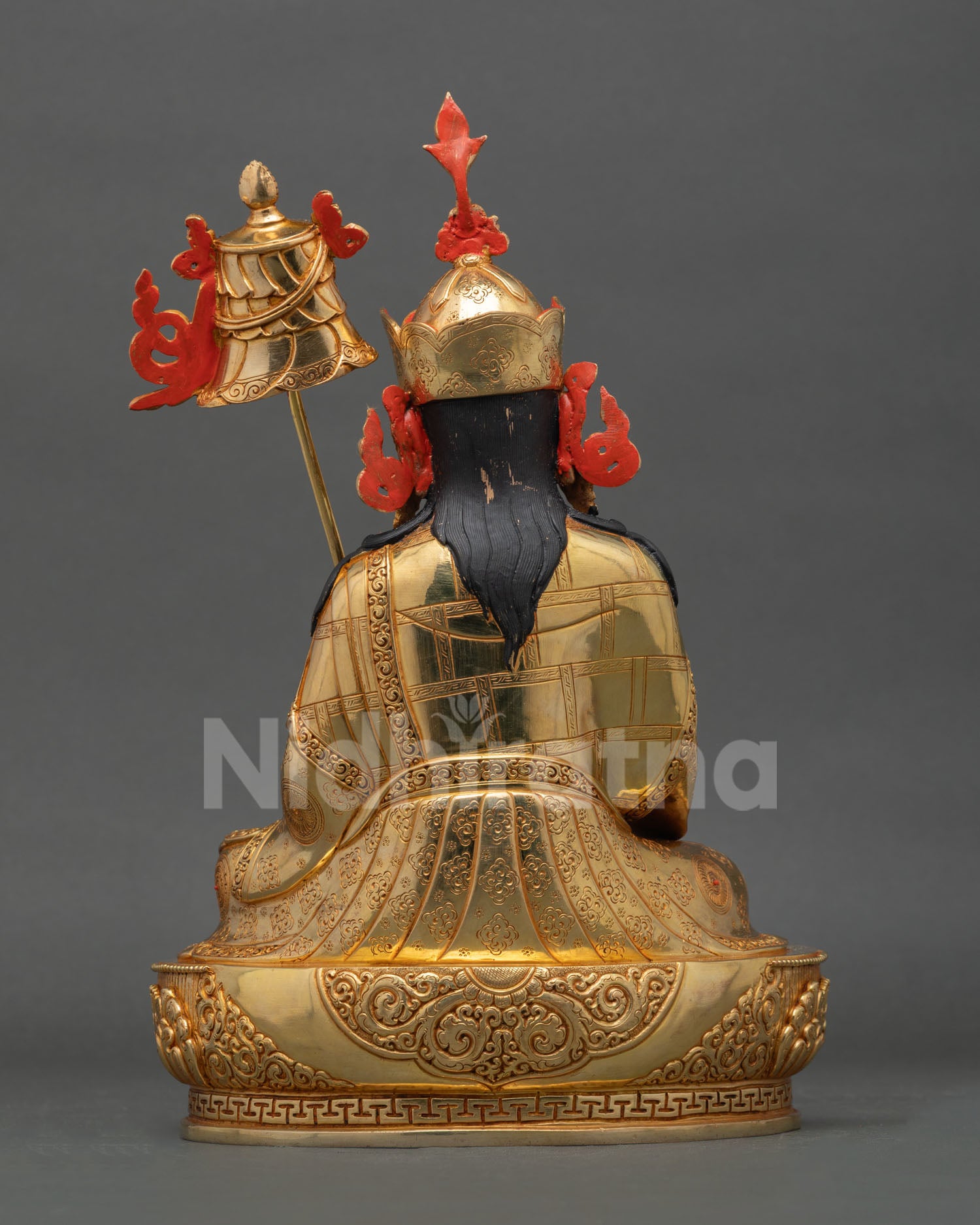 Back view of handcrafted Guru Norlha statue from Nepal showcasing Himalayan copper artistry and sacred engraved designs