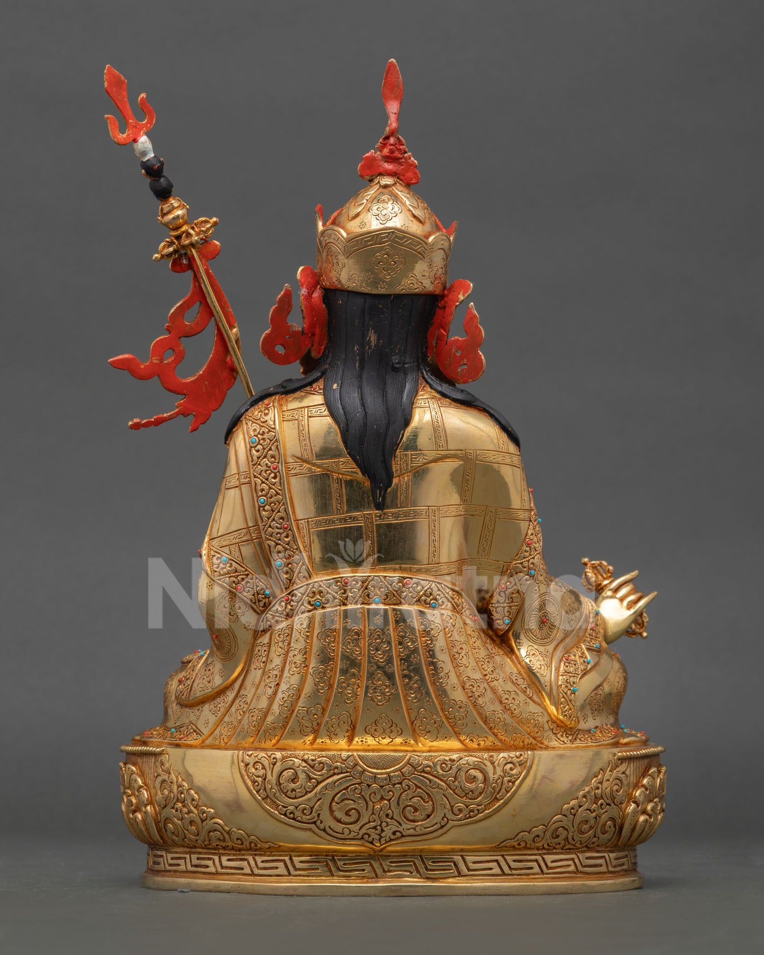 Back view of handcrafted Guru Rinpoche statue from Patan Nepal showcasing gold gilded copper and ornamental traditional design
