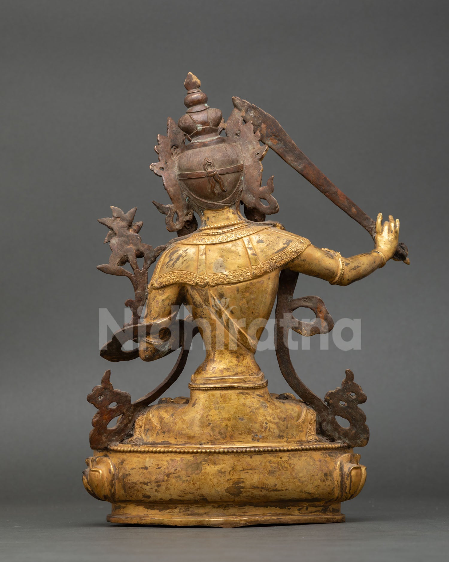 Back view of handmade Manjushri statue Nepal antique finish copper sculpture flowing robes intricate detailing Himalayan Buddhist altar decor piece