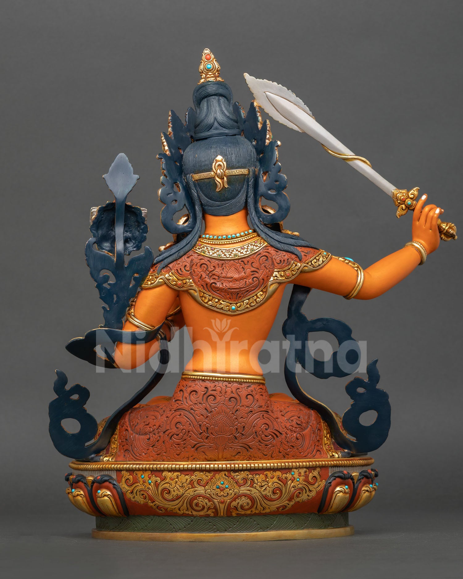 Back view of handmade Manjushri statue showing detailed metal craftsmanship gold gilded accents and traditional Newari artistry