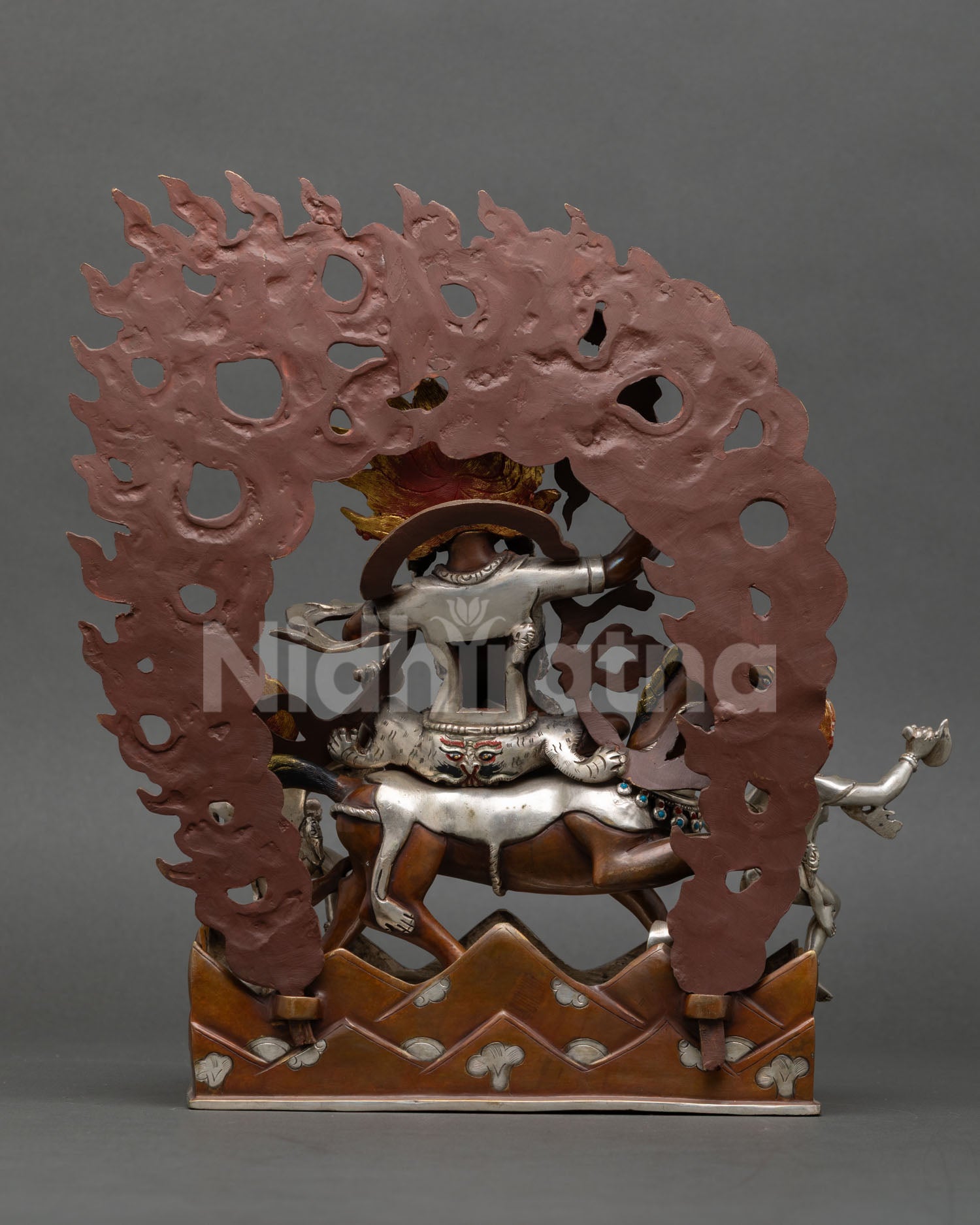 Back view of handmade Palden Lhamo statue with ornate flaming halo and Nepalese craftsmanship