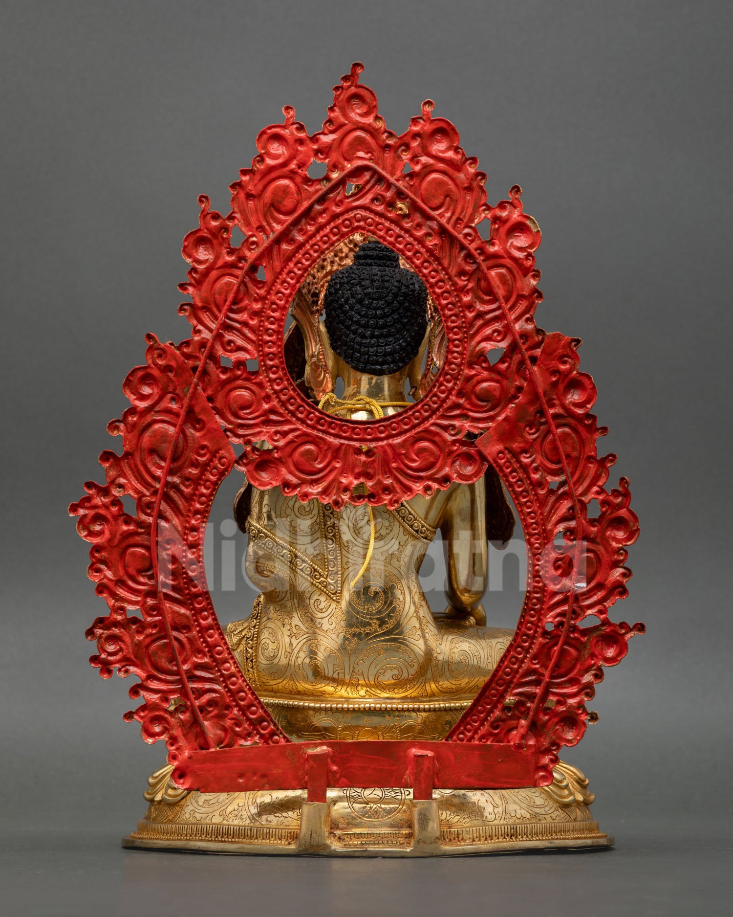 Back view of Jowo Rinpoche statue with intricate monk robe detailing floral patterns and traditional Nepalese Buddhist metalwork art