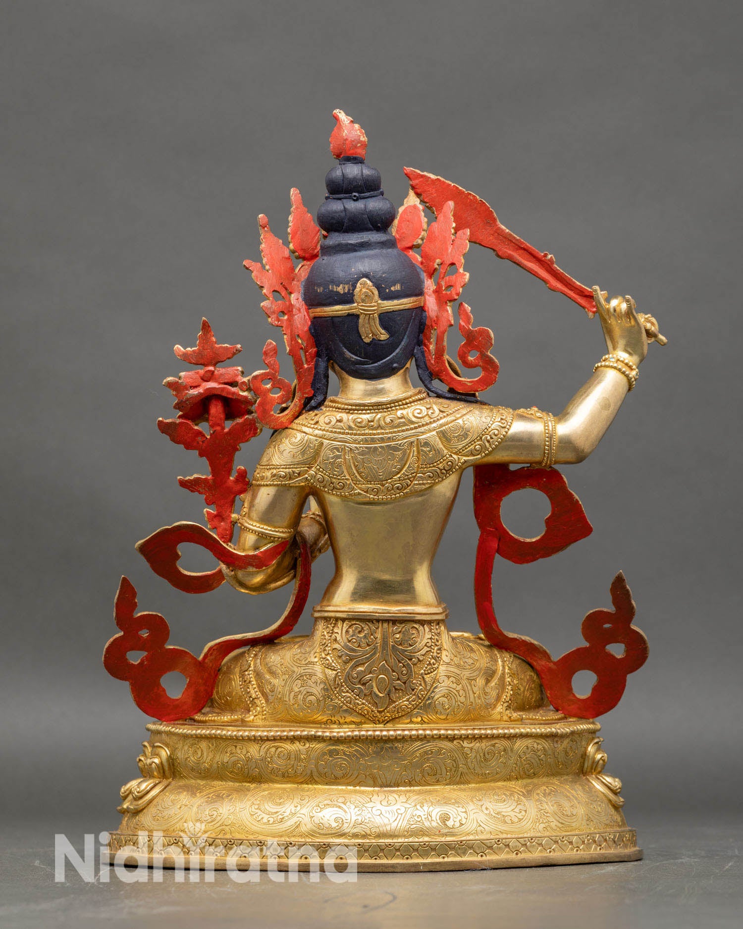 Back view of Manjushri statue intricate carvings semi precious stones gold finish Himalayan Buddhist sculpture