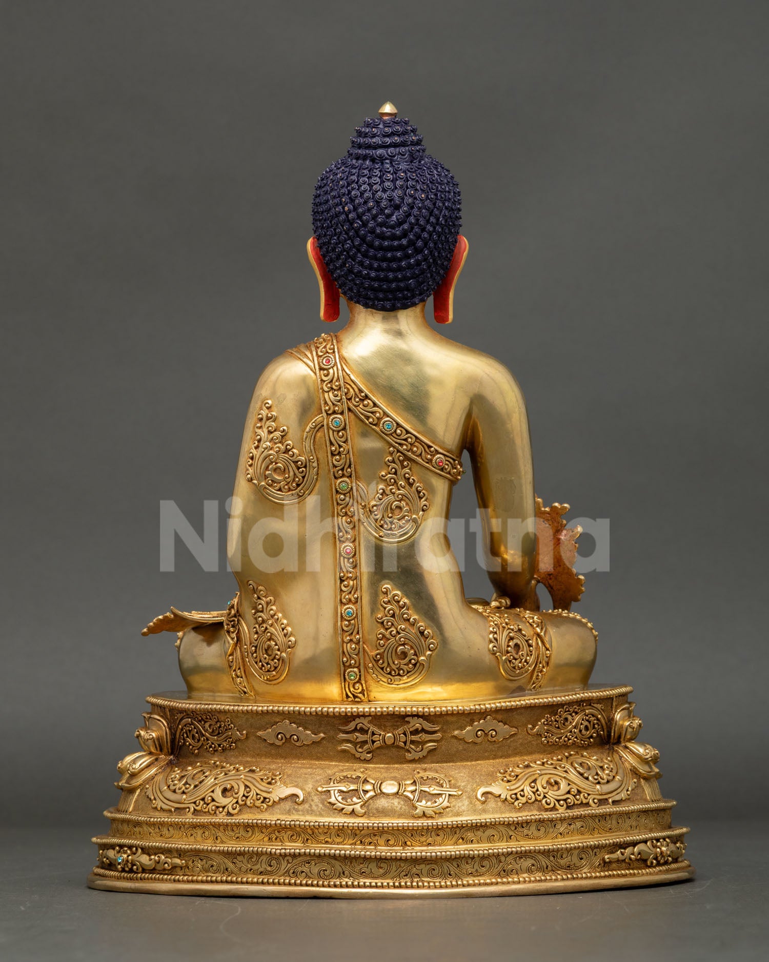 Medicine Buddha back view, hand-finished copper, engraved lotus base, gold fire-gilded — Nepal