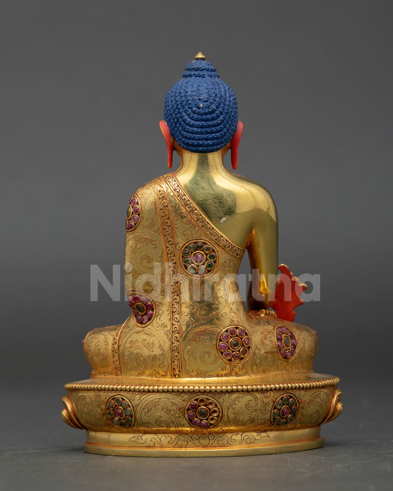 Back view of Medicine Buddha Buddhist statue with ornate craftsmanship flowing robe detailing and authentic lost wax Nepalese metal artistry