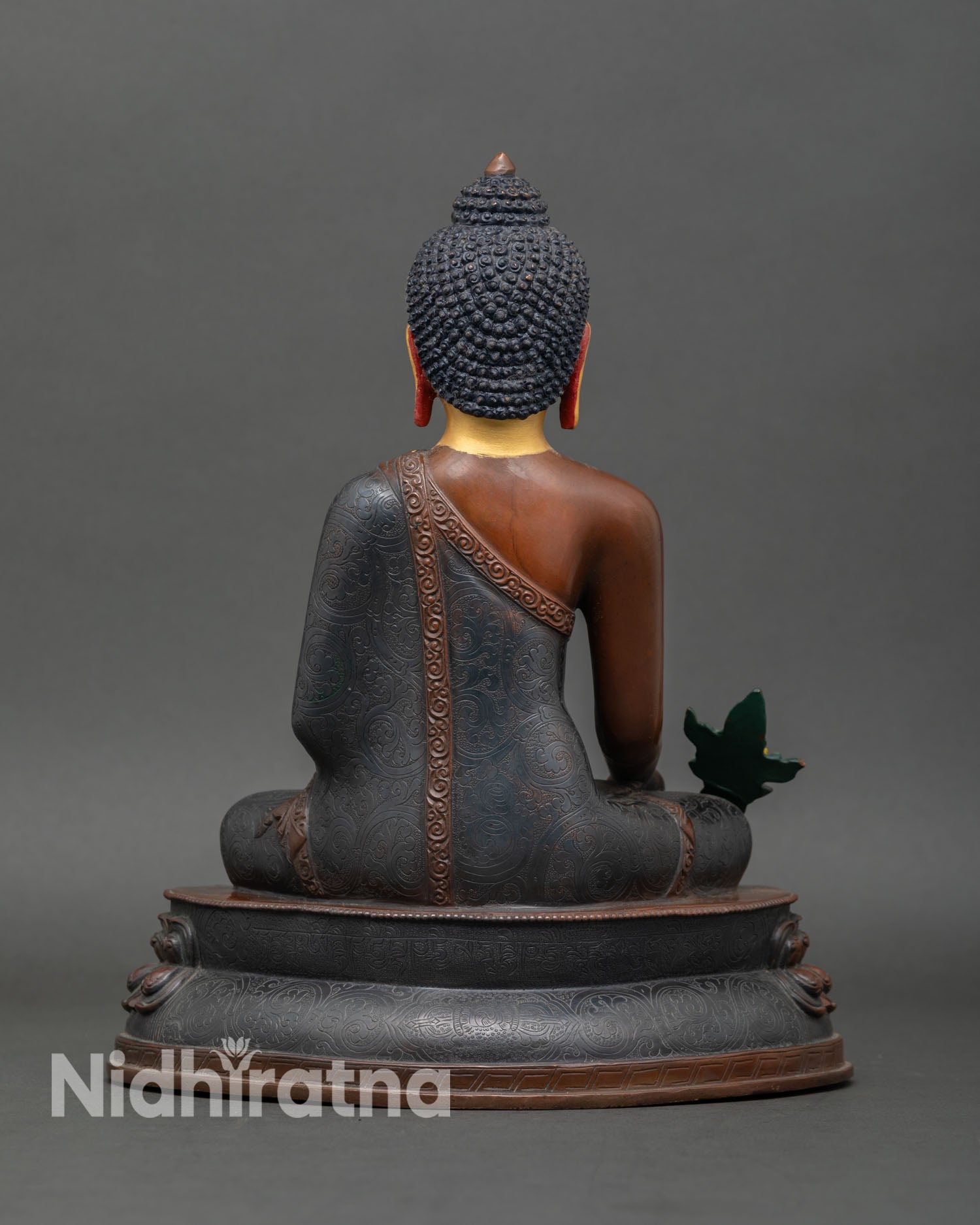 Back view of Medicine Buddha statue oxidized finish flowing robes copper handmade Nepal Buddhist healing art spiritual altar decor sculpture