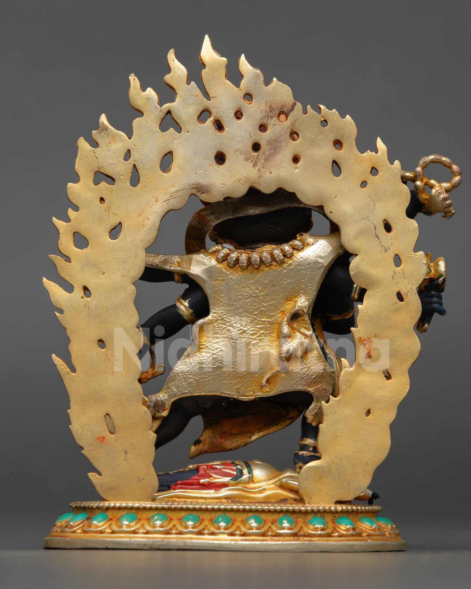 Back view Nepalese Six Armed Mahakala statue with blazing flame halo gold plated finish