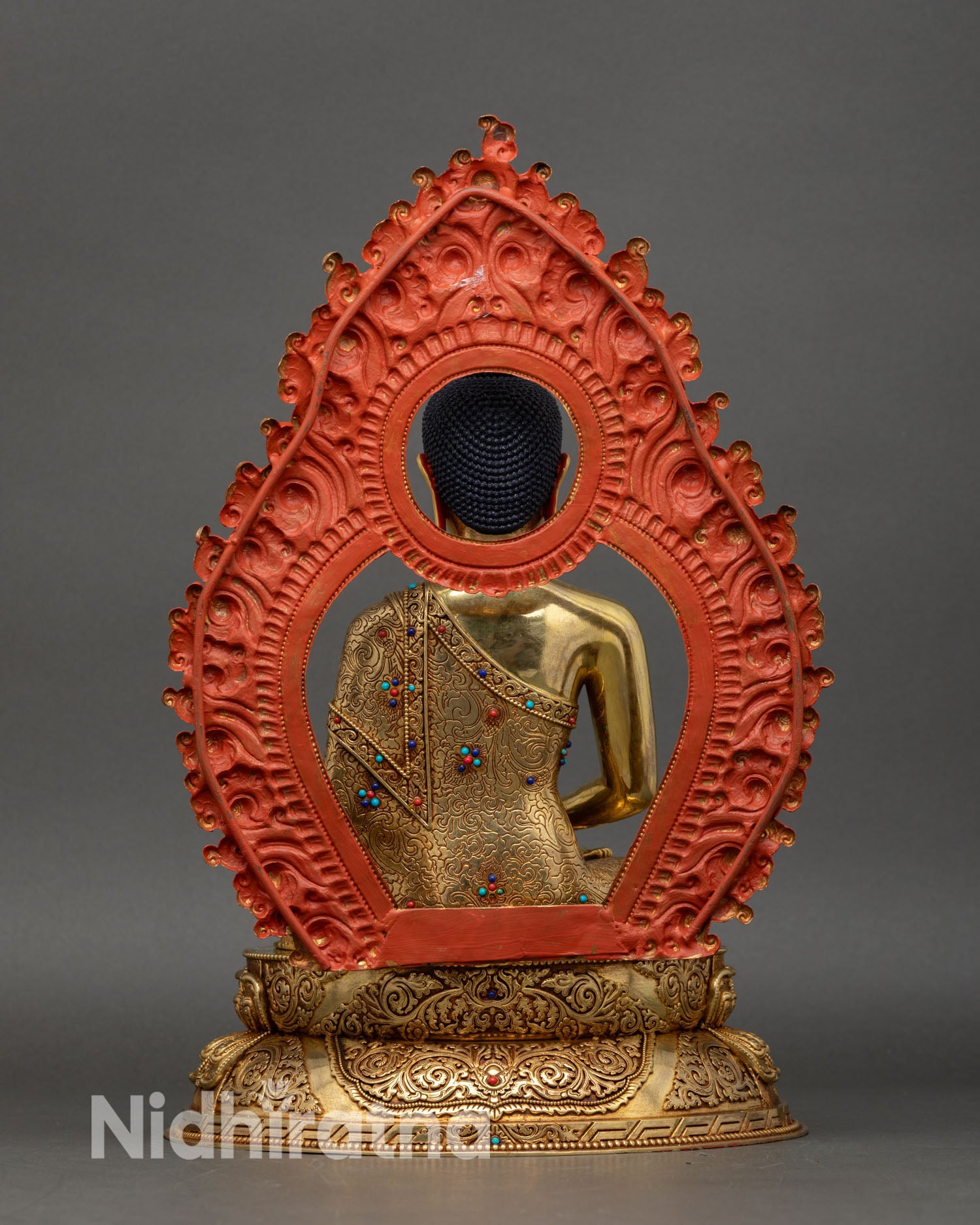 back view of amitabha buddha statue, ornate lotus seat and decorative halo details