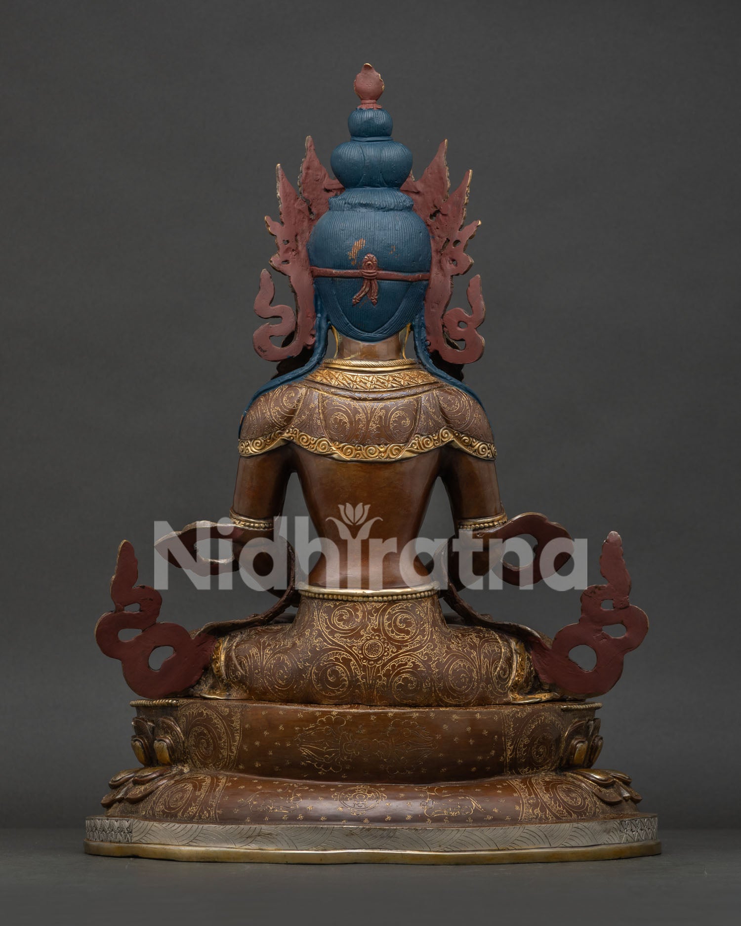 back view of amitayus statue displaying handcrafted repoussé and chased metalwork