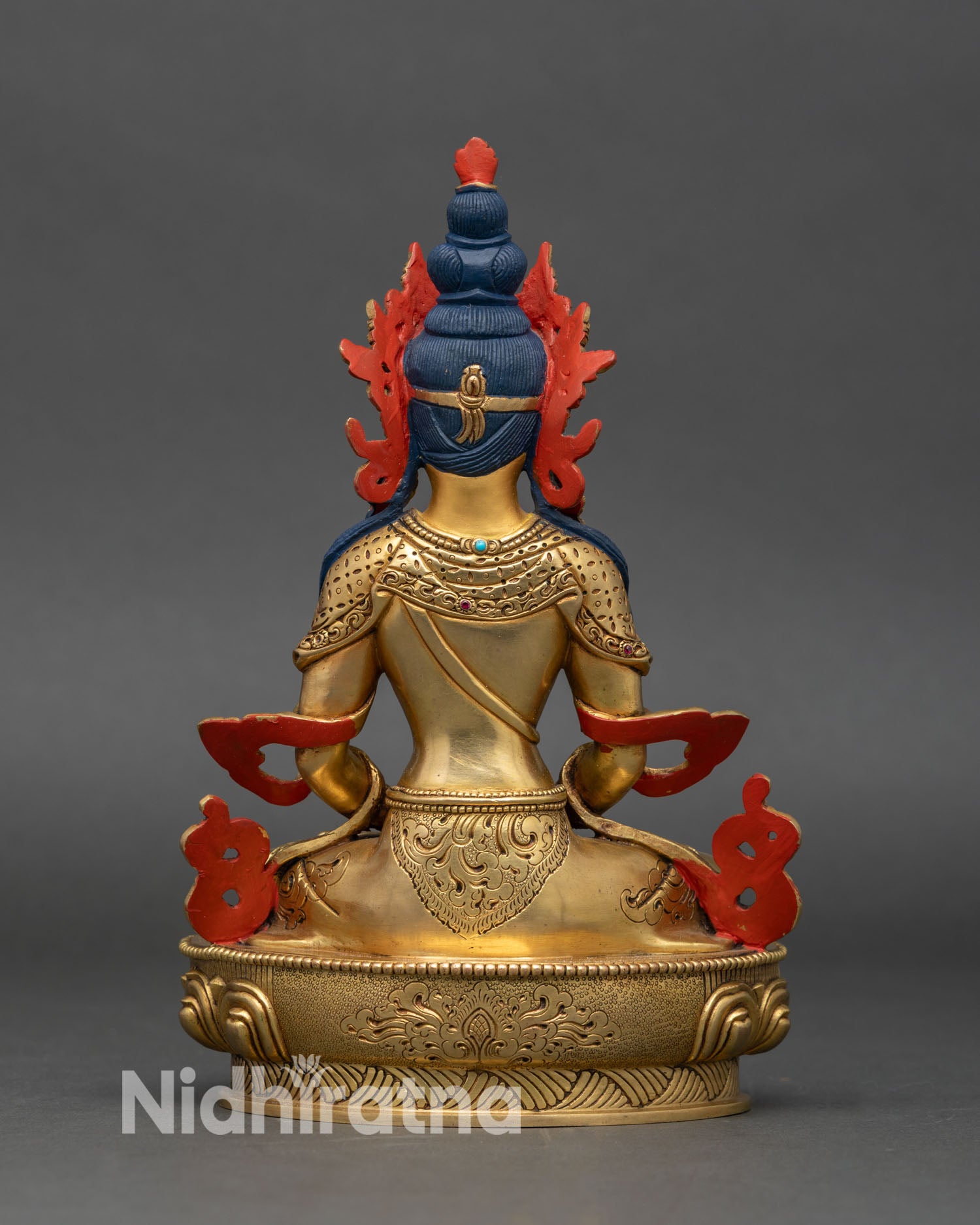 Back view of Amitayus statue showing engraved details and hollow chamber for mantras